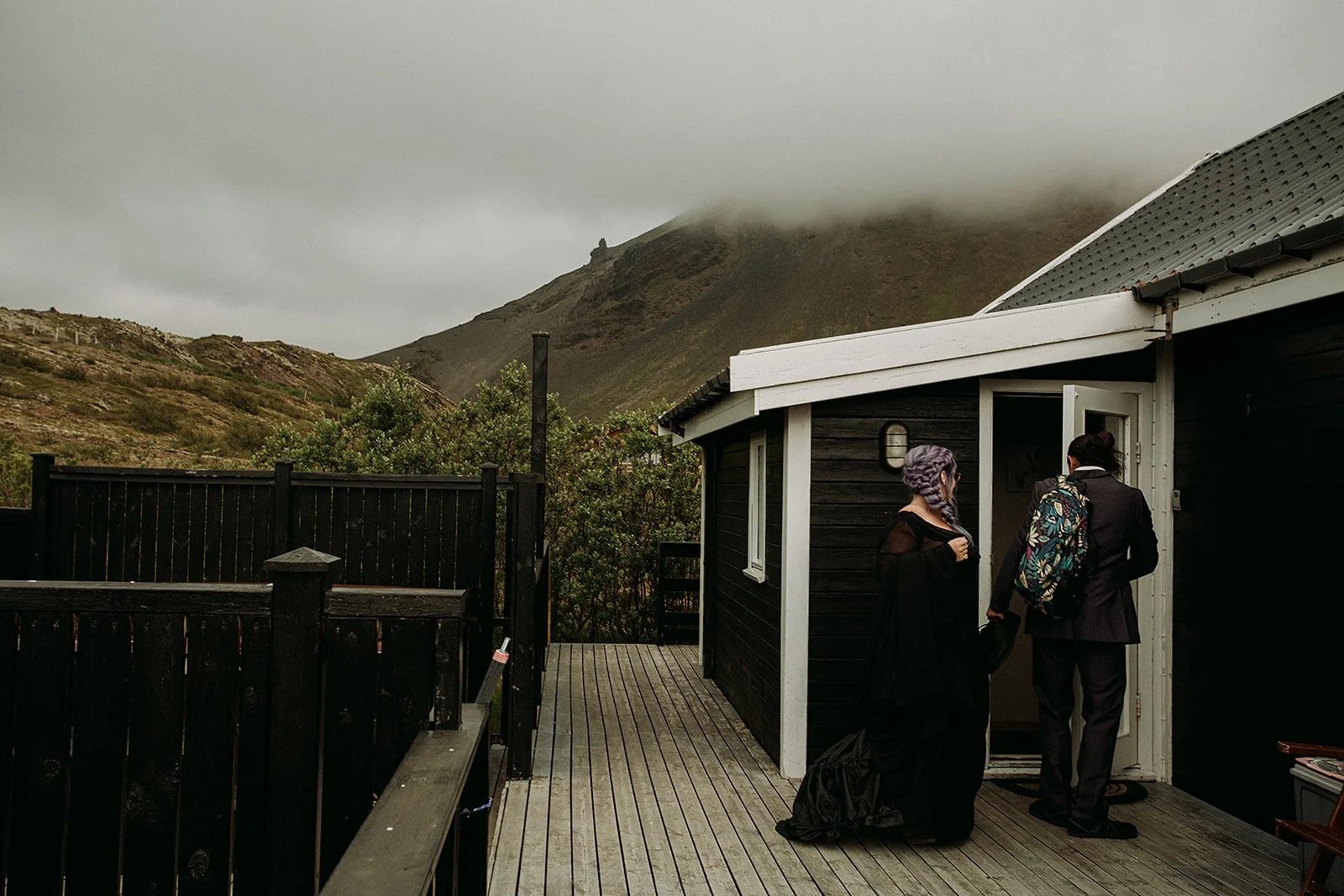 Alternative Iceland elopement couple wearing black wedding dress and purple hair — getting ready for the elopement 