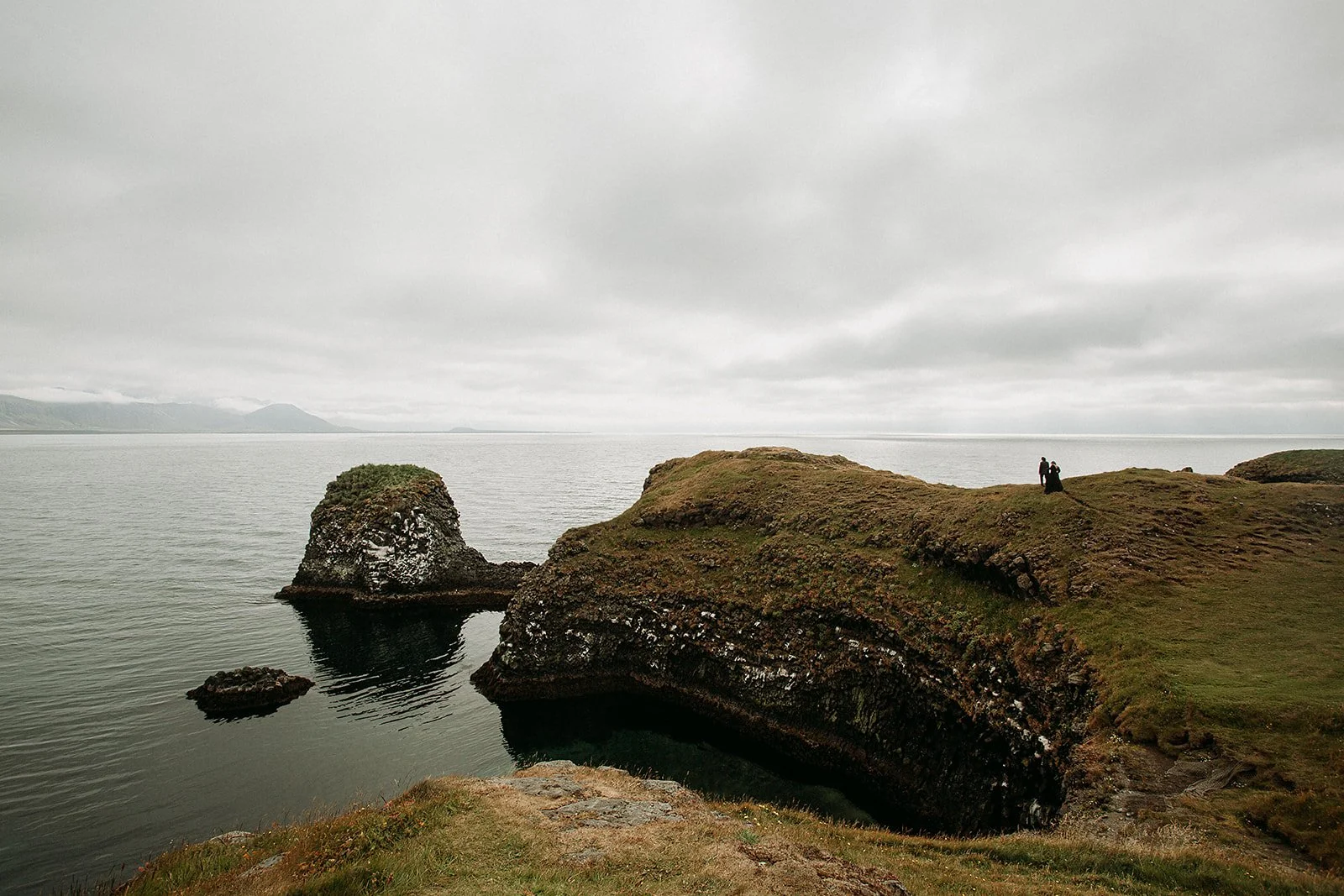Alternative Iceland elopement couple wearing black wedding dress and purple hair — couple portraits