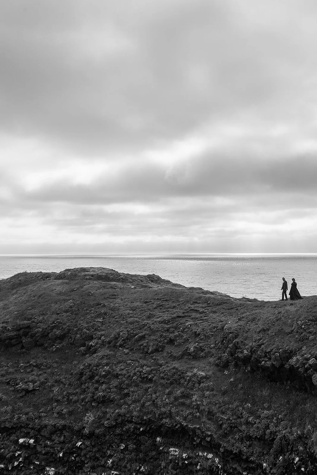 Alternative Iceland elopement couple wearing black wedding dress and purple hair — couple portraits