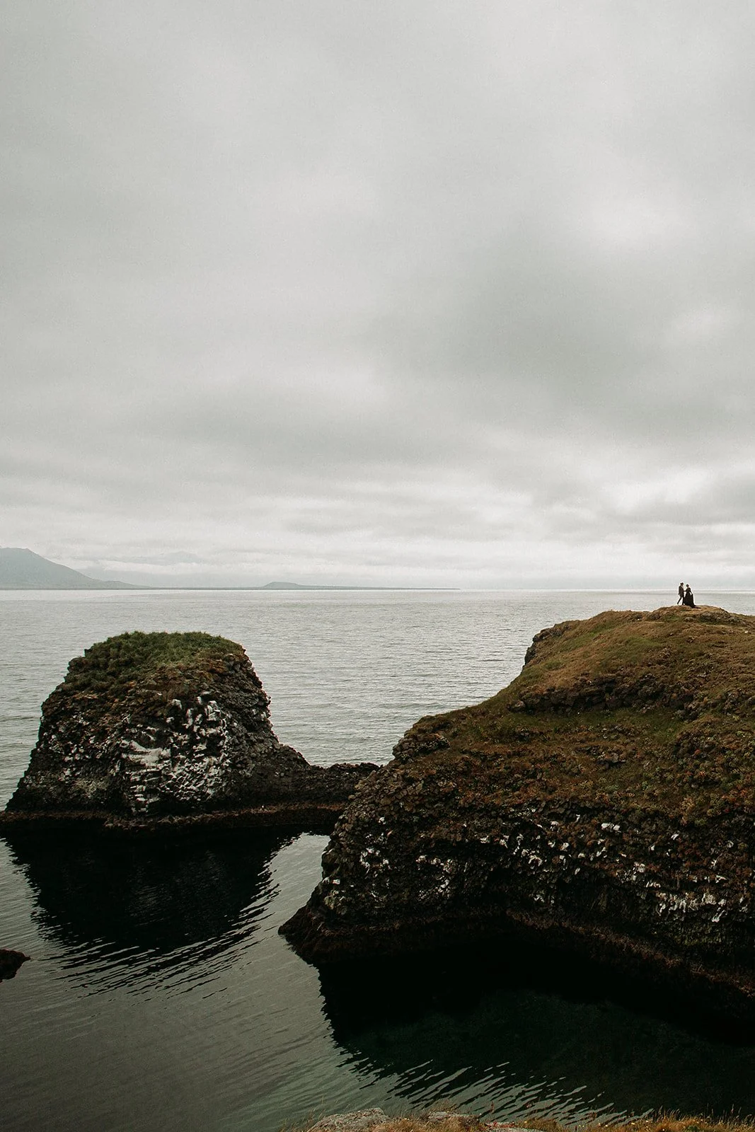 Alternative Iceland elopement couple wearing black wedding dress and purple hair — couple portraits