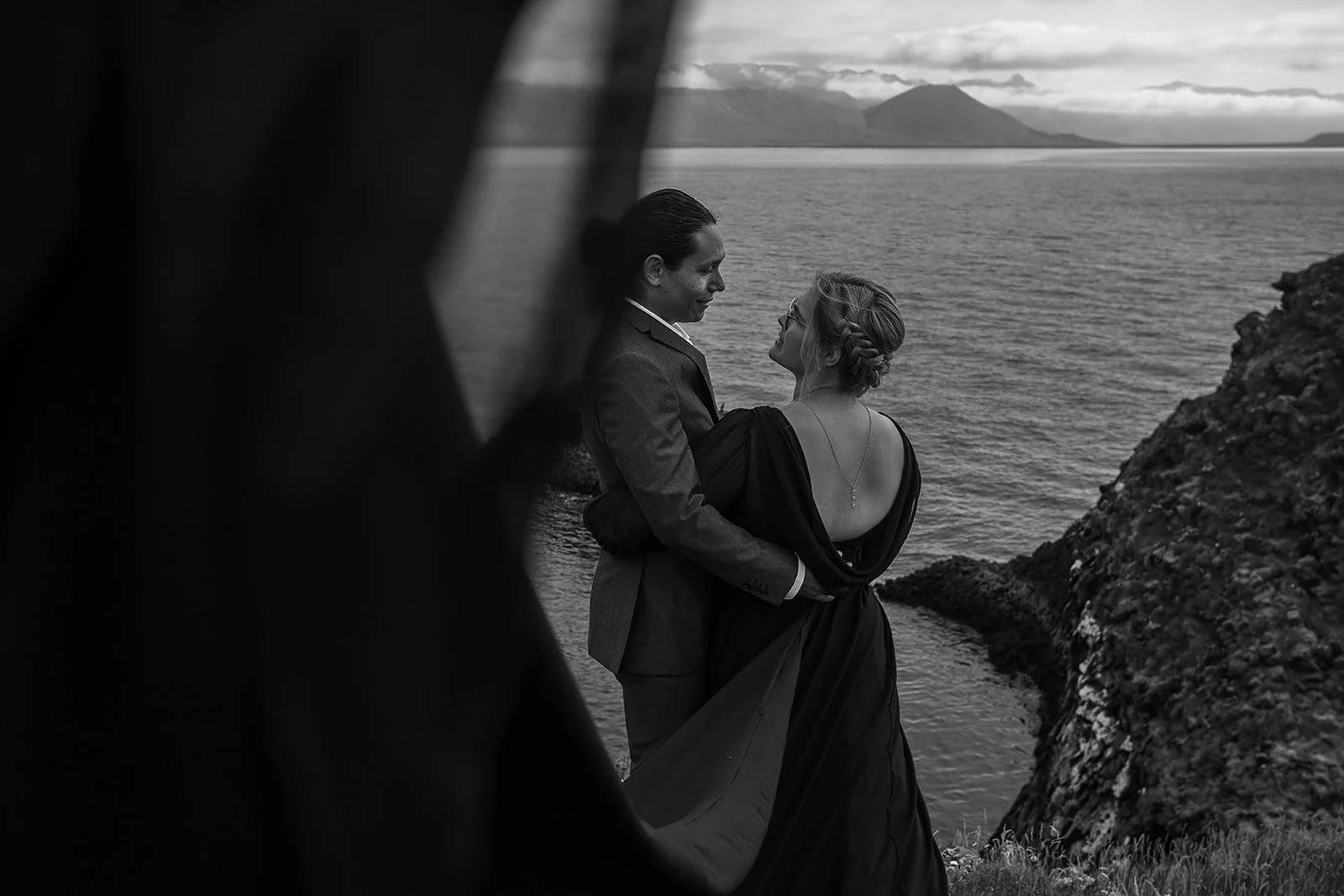 Alternative Iceland elopement couple wearing black wedding dress and purple hair — couple portraits sea cliffs Snæfellsnes