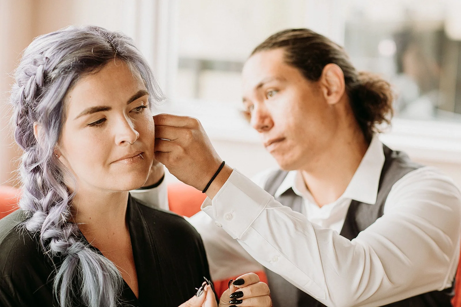 Alternative Iceland elopement couple wearing black wedding dress and purple hair — getting ready for the elopement 