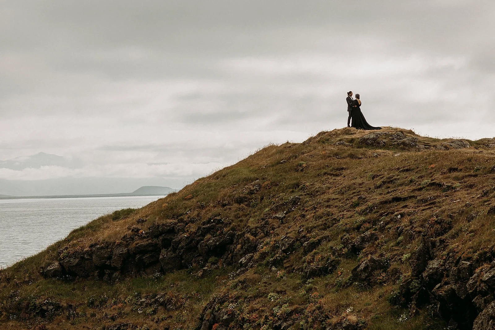 Alternative Iceland elopement couple wearing black wedding dress and purple hair — couple portraits