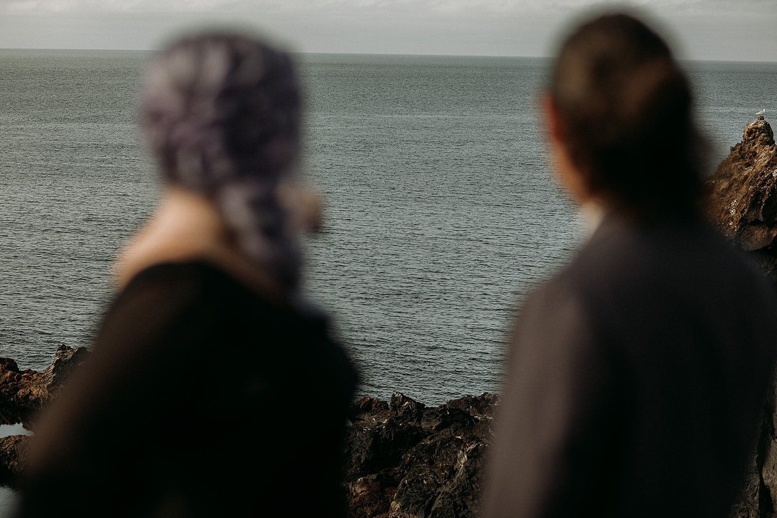 Alternative Iceland elopement couple wearing black wedding dress and purple hair — couple portraits