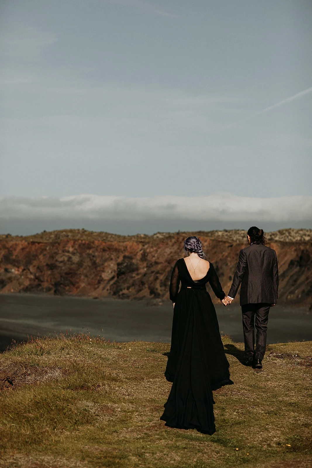 Alternative Iceland elopement couple wearing black wedding dress and purple hair — couple portraits
