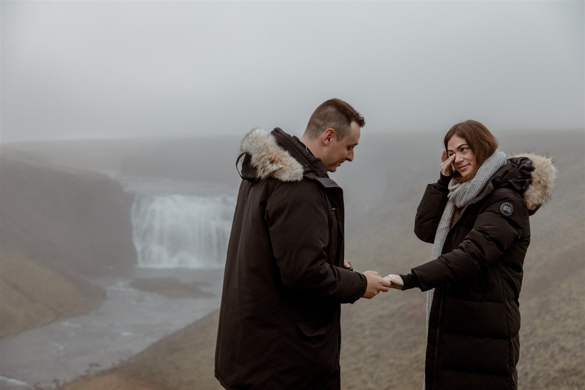  Secret Iceland Proposal at a Foggy Winter Waterfall by a local Iceland Engagement &amp; Proposal Photographer and planner —couple happy 