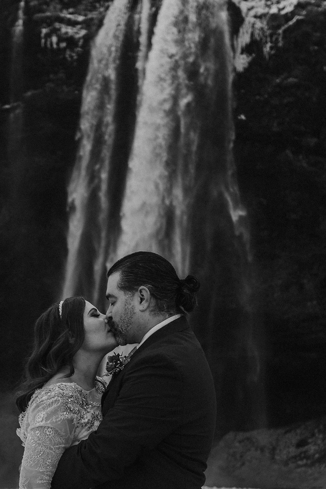 A Winter Iceland Elopement at Skógafoss (Skogafoss) and Glacier — couple in front of the waterfall