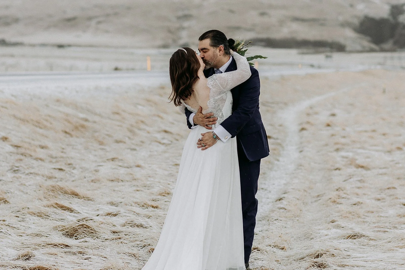 A Winter Iceland Elopement at Skógafoss (Skogafoss) and Glacier — couple in front of mountains