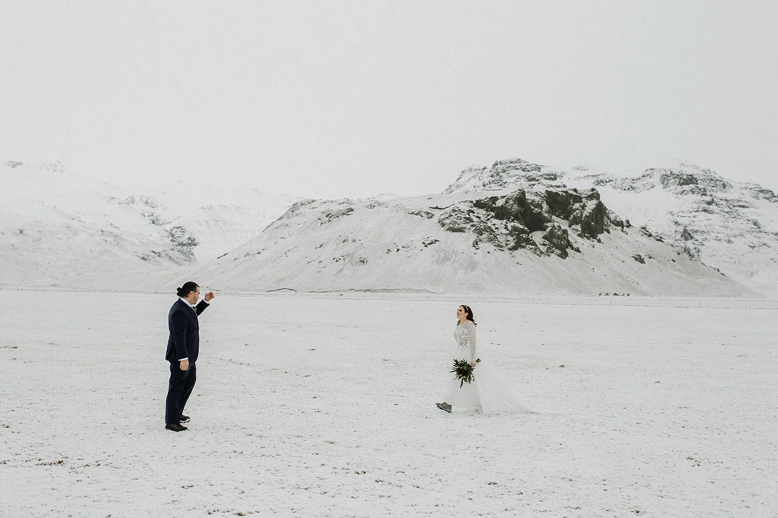 A Winter Iceland Elopement at Skógafoss (Skogafoss) and Glacier — couple in snowy field