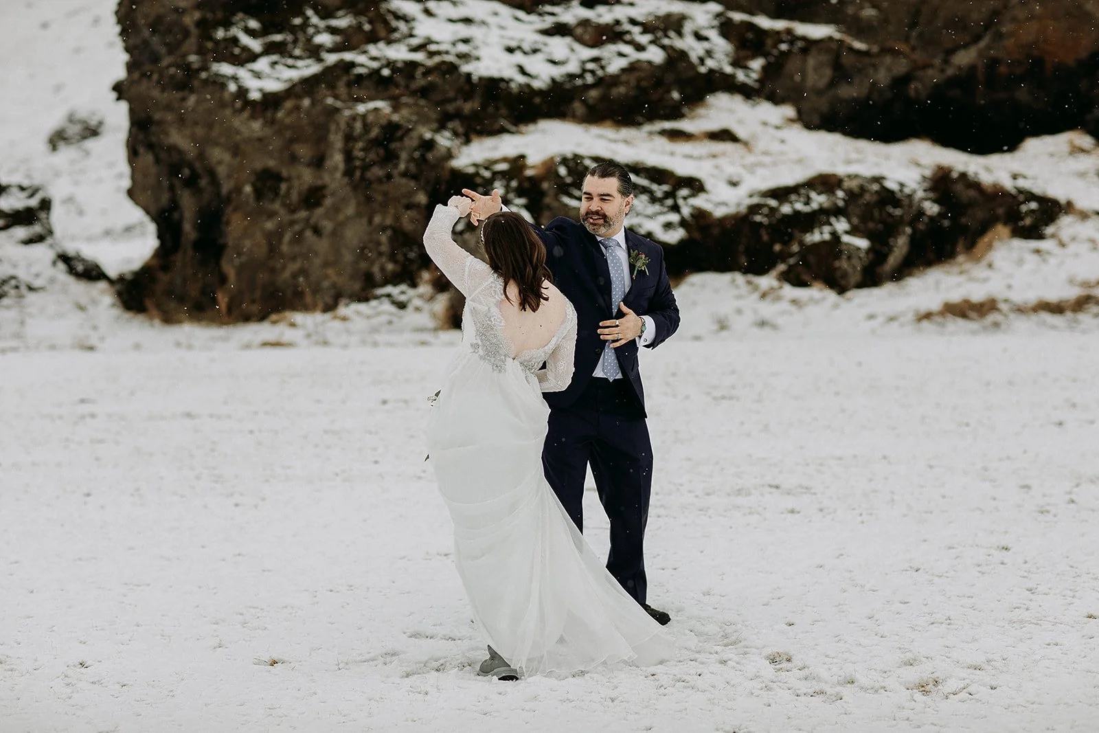 A Winter Iceland Elopement at Skógafoss (Skogafoss) and Glacier — couple in snowy field
