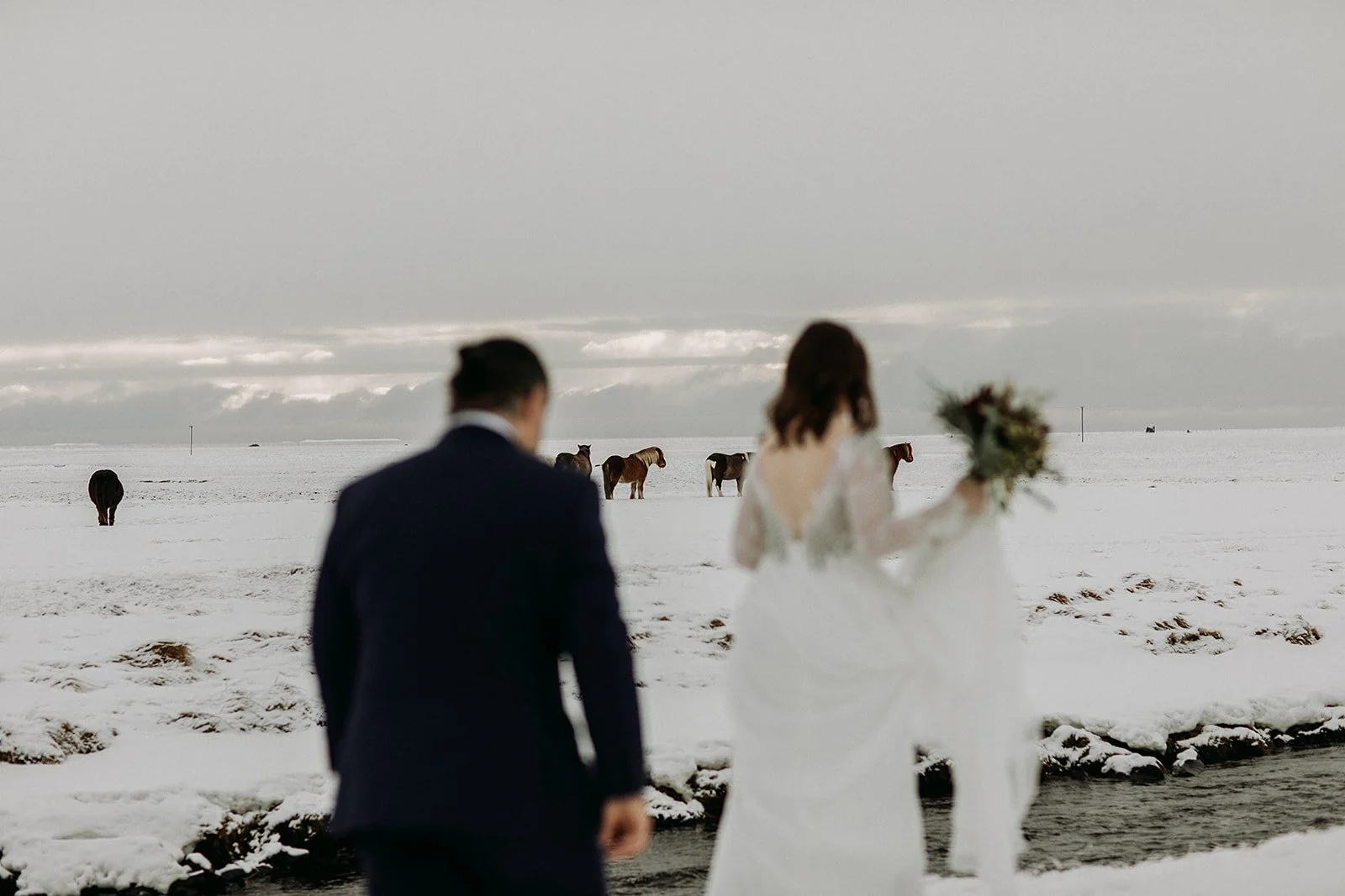 A Winter Iceland Elopement at Skógafoss (Skogafoss) and Glacier — couple in snowy field