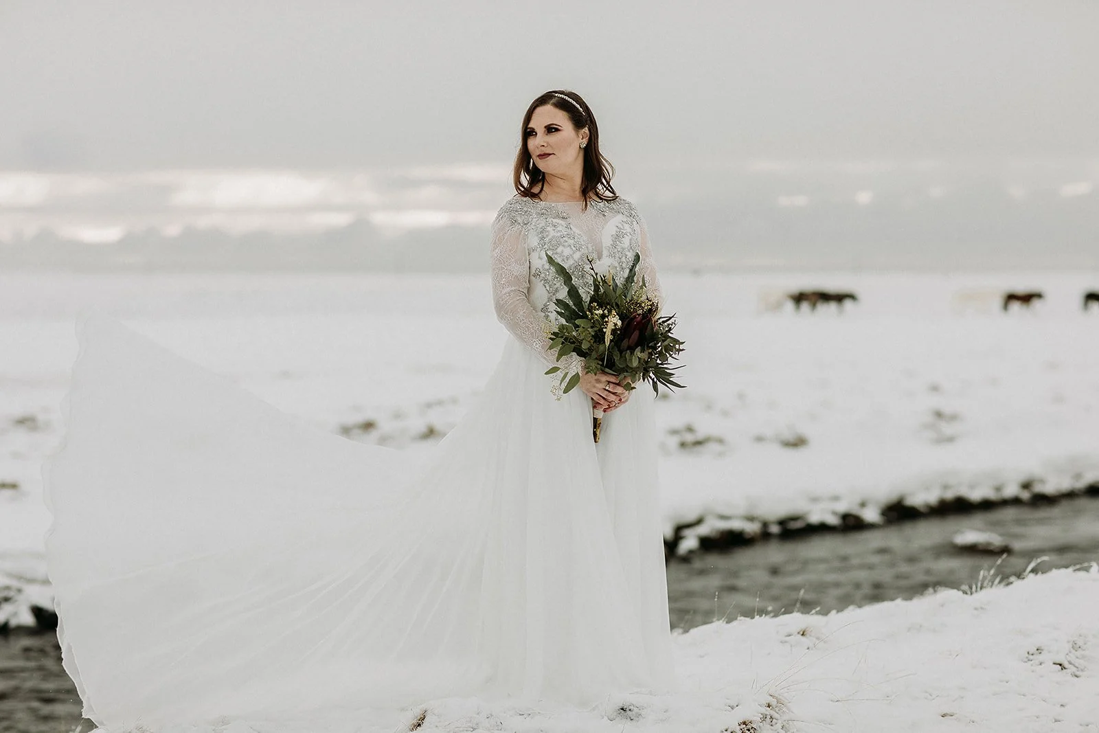 A Winter Iceland Elopement at Skógafoss (Skogafoss) and Glacier — couple in snowy field