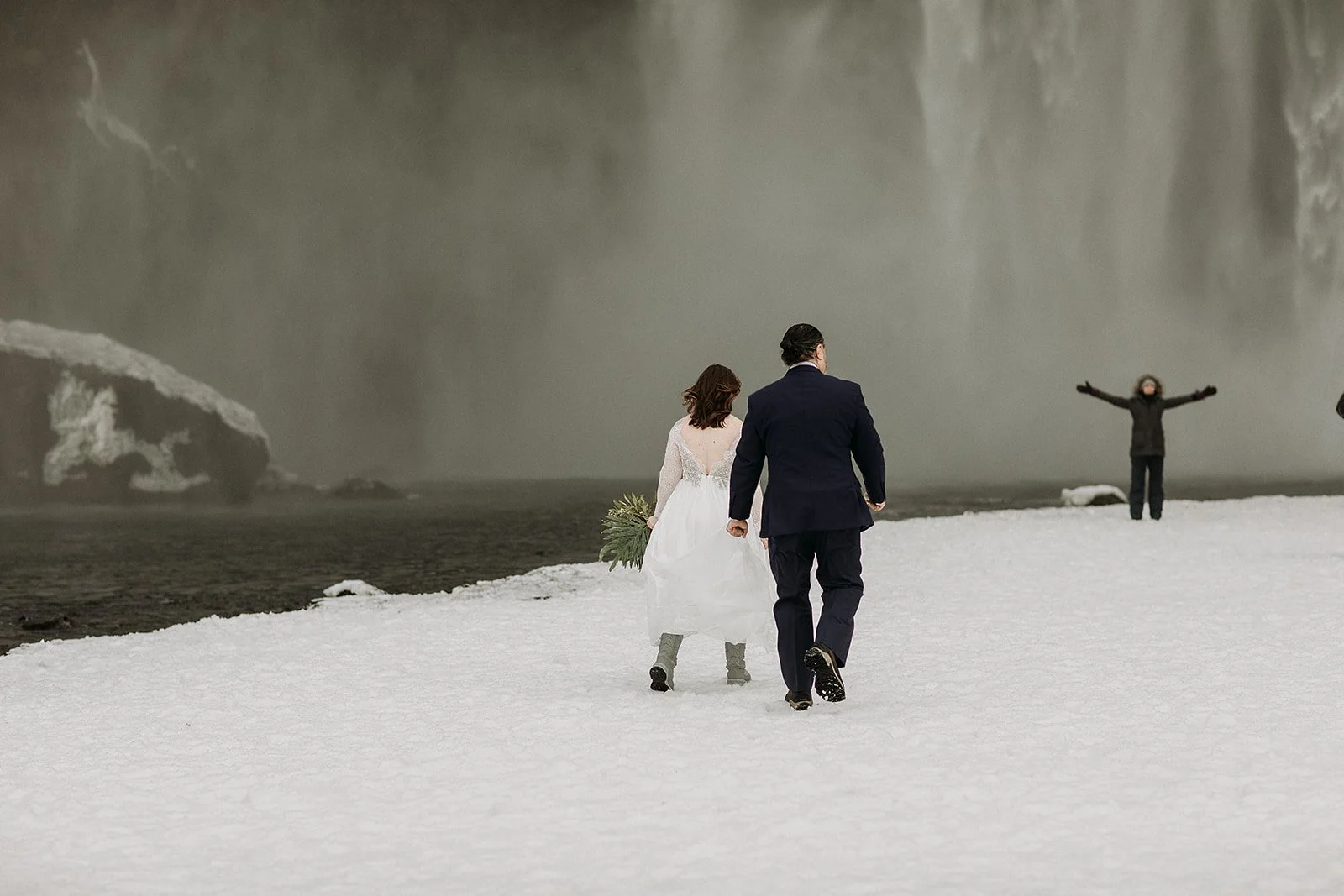 A Winter Iceland Elopement at Skógafoss (Skogafoss) and Glacier — couple at waterfall