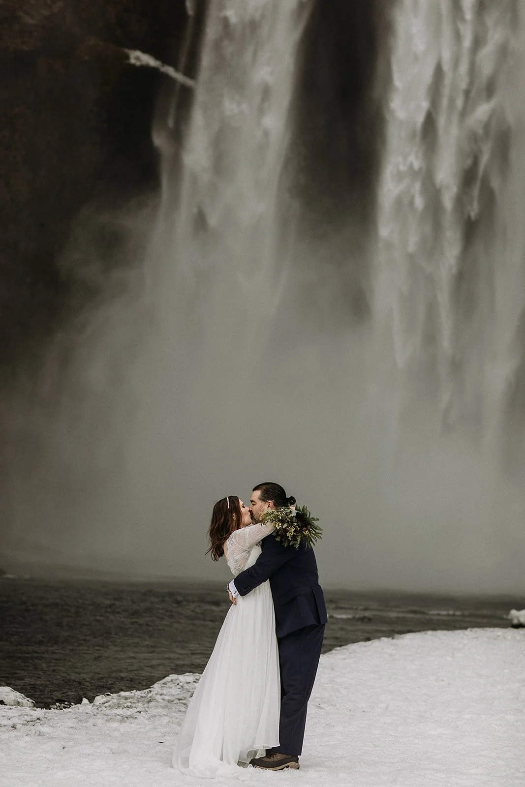 A Winter Iceland Elopement at Skógafoss (Skogafoss) and Glacier — couple at waterfall