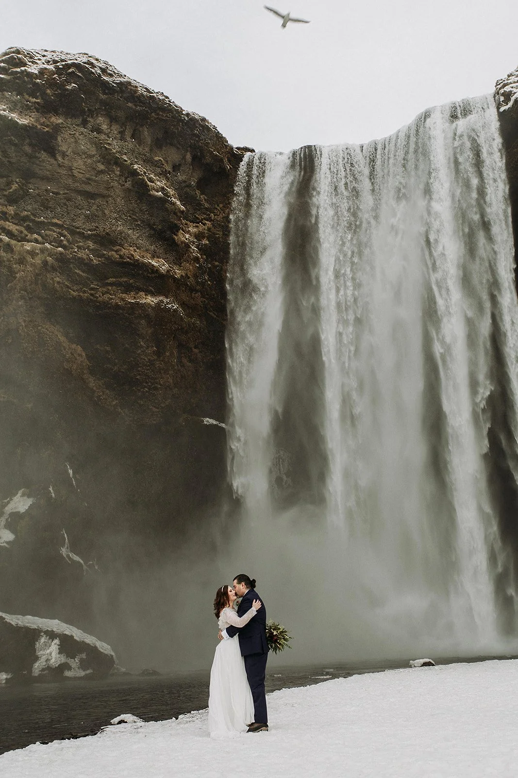 A Winter Iceland Elopement at Skógafoss (Skogafoss) and Glacier — couple at waterfall