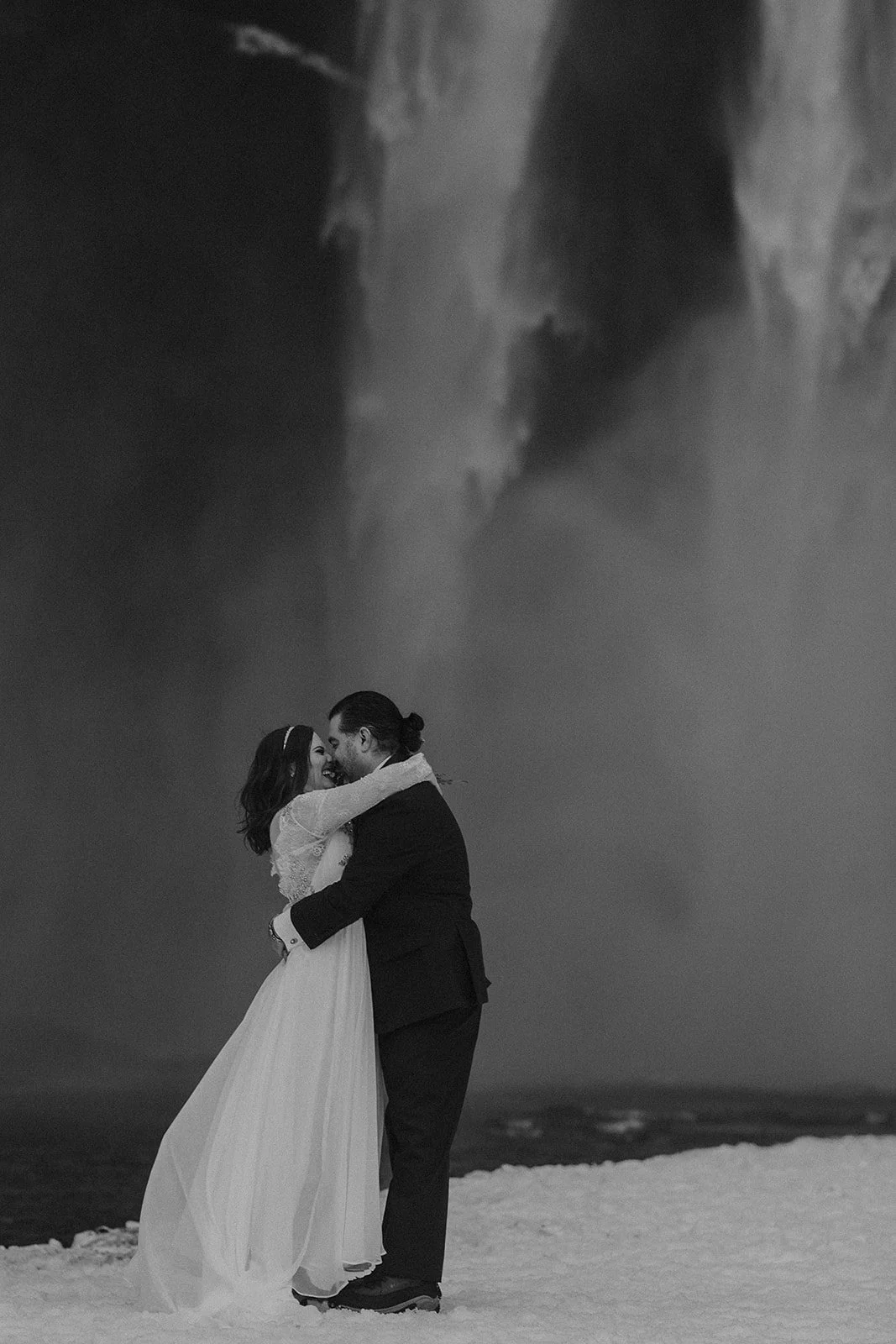 A Winter Iceland Elopement at Skógafoss (Skogafoss) and Glacier — couple at waterfall