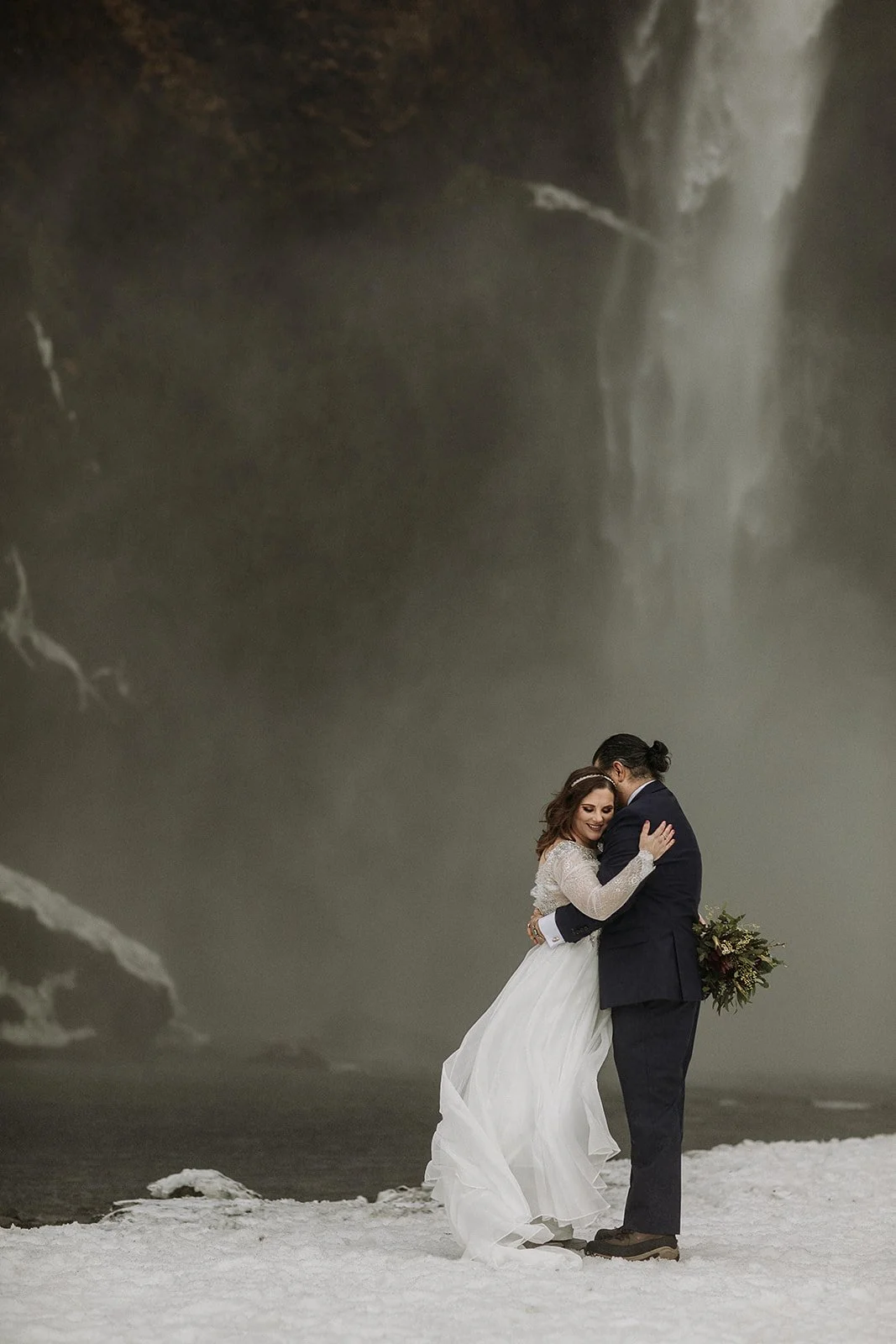 A Winter Iceland Elopement at Skógafoss (Skogafoss) and Glacier — couple at waterfall