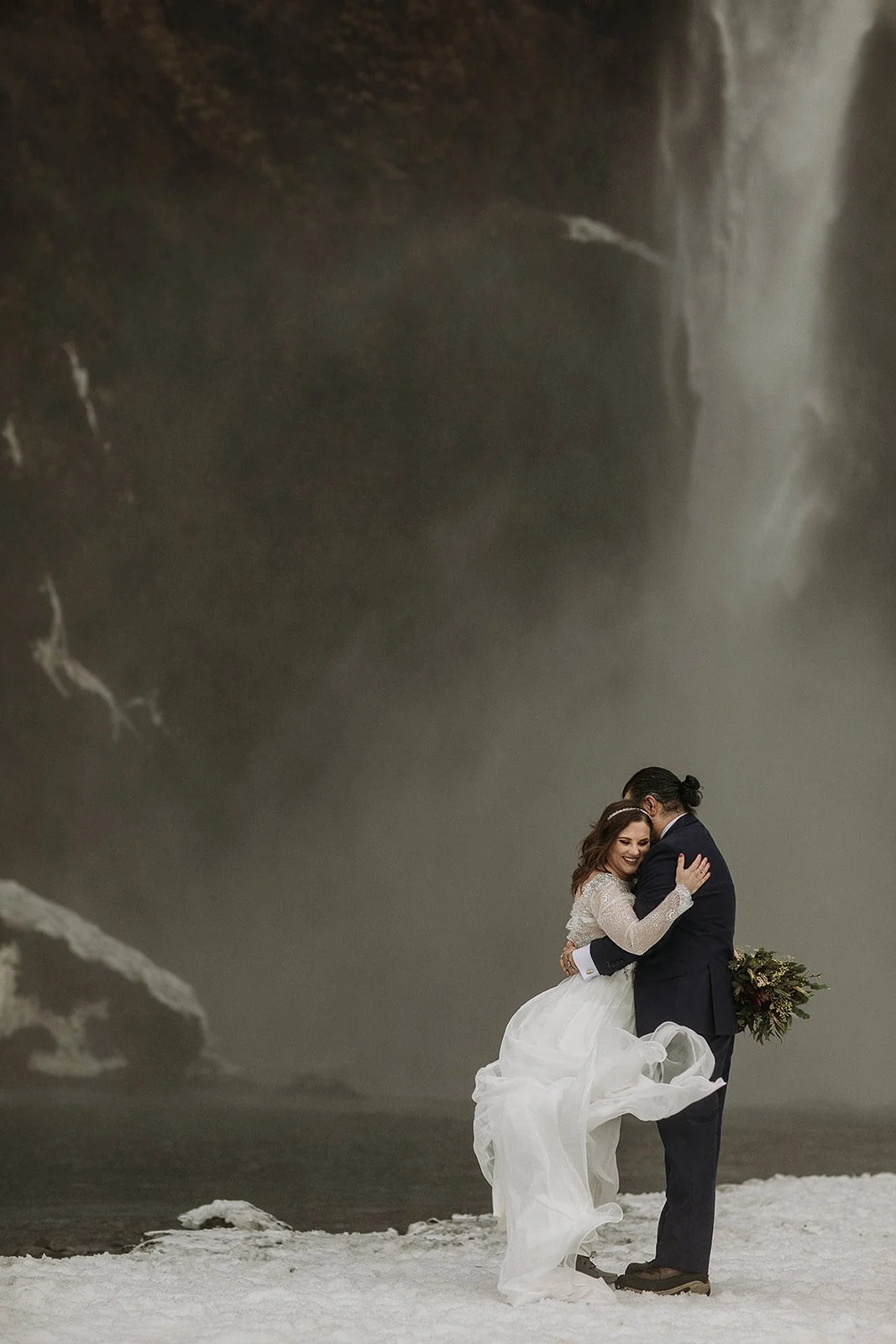 A Winter Iceland Elopement at Skógafoss (Skogafoss) and Glacier — couple at waterfall