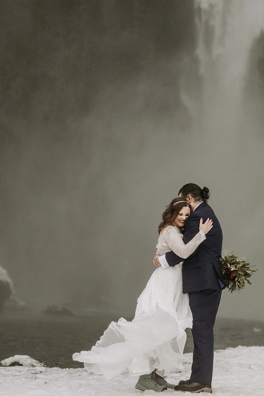 A Winter Iceland Elopement at Skógafoss (Skogafoss) and Glacier — couple at waterfall