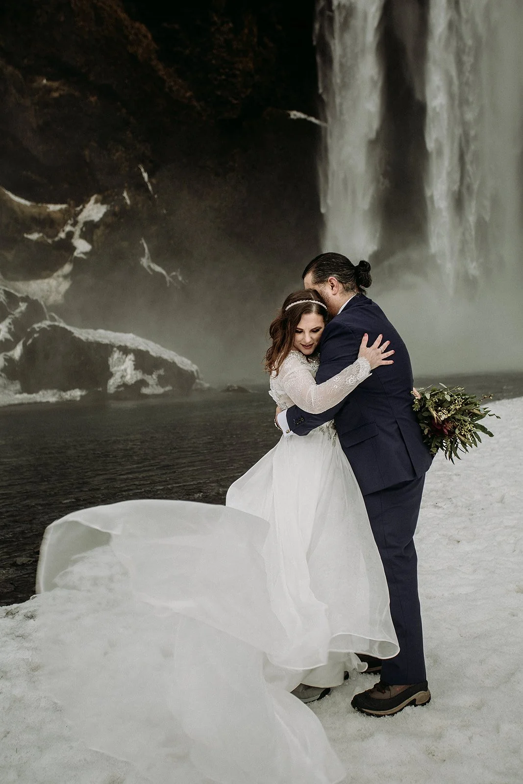 A Winter Iceland Elopement at Skógafoss (Skogafoss) and Glacier — couple at waterfall