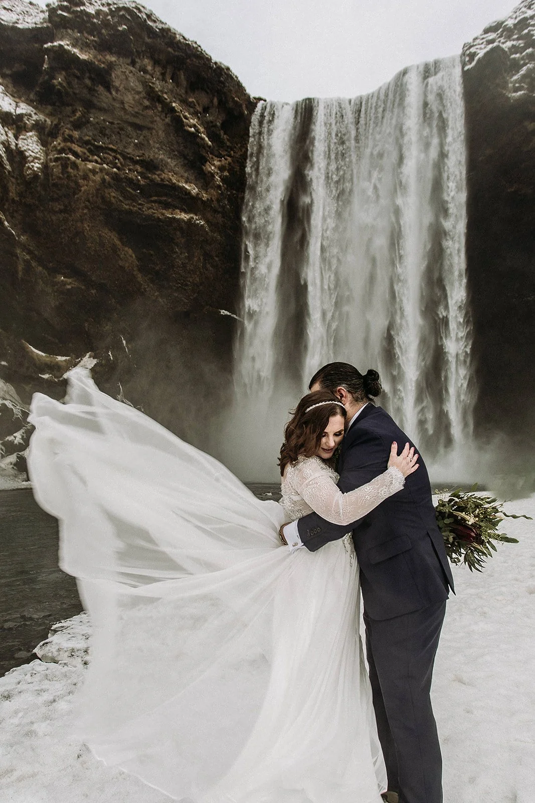 A Winter Iceland Elopement at Skógafoss (Skogafoss) and Glacier — couple at waterfall