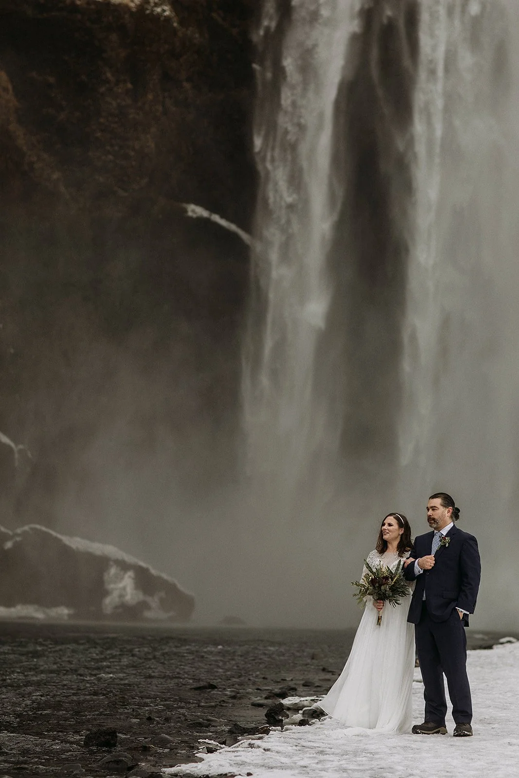 A Winter Iceland Elopement at Skógafoss (Skogafoss) and Glacier — couple at waterfall