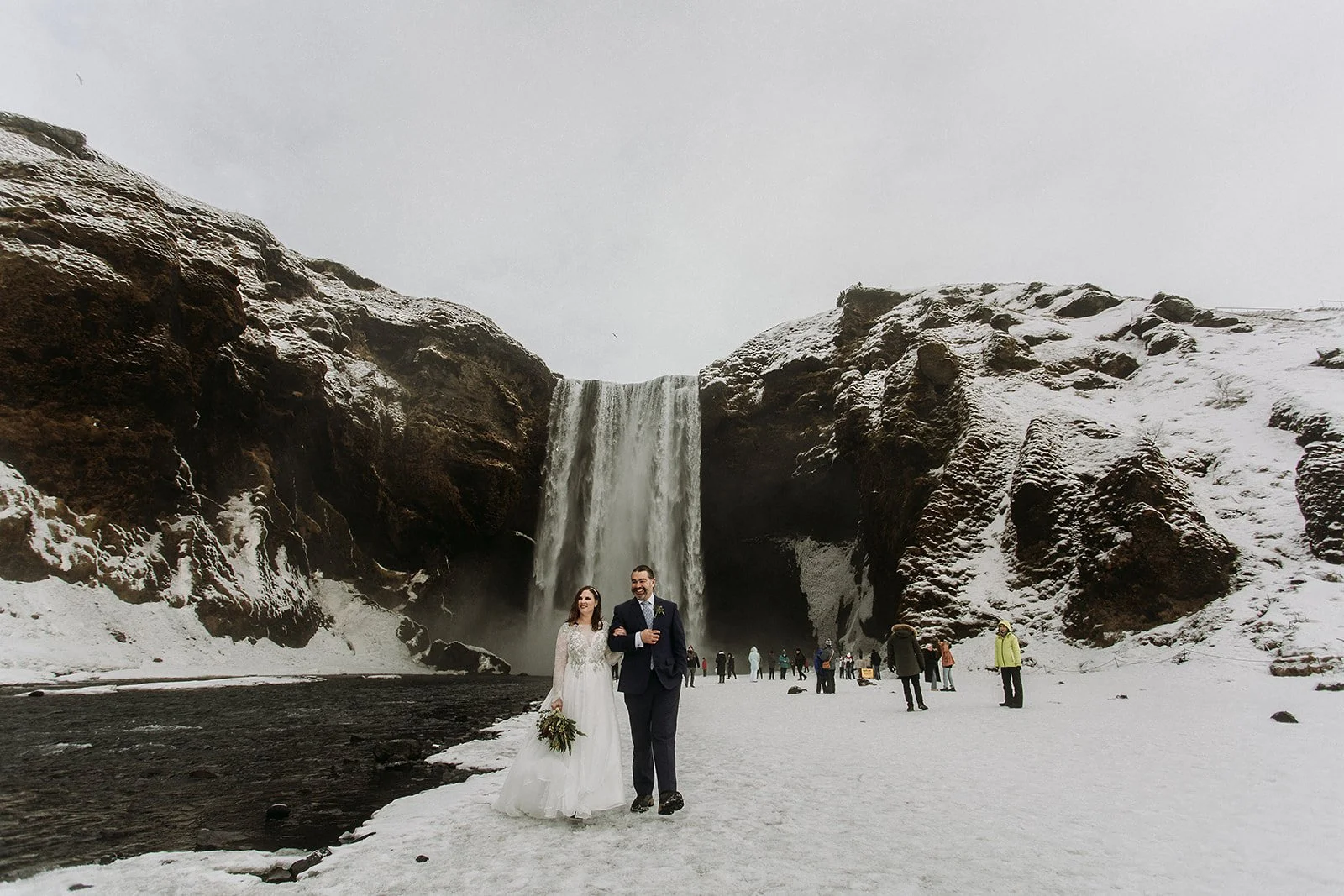A Winter Iceland Elopement at Skógafoss (Skogafoss) and Glacier — couple at waterfall