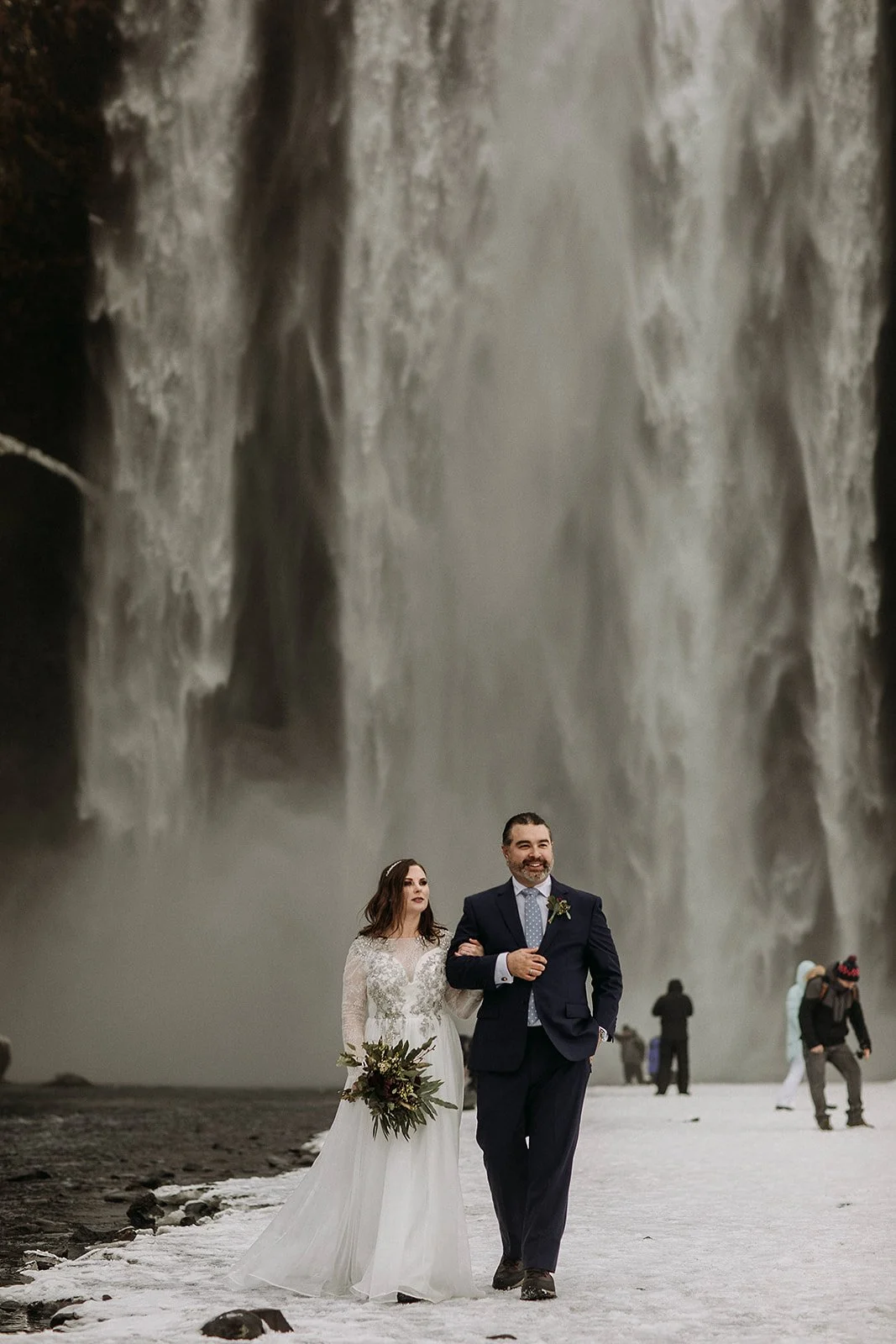 A Winter Iceland Elopement at Skógafoss (Skogafoss) and Glacier — couple at waterfall