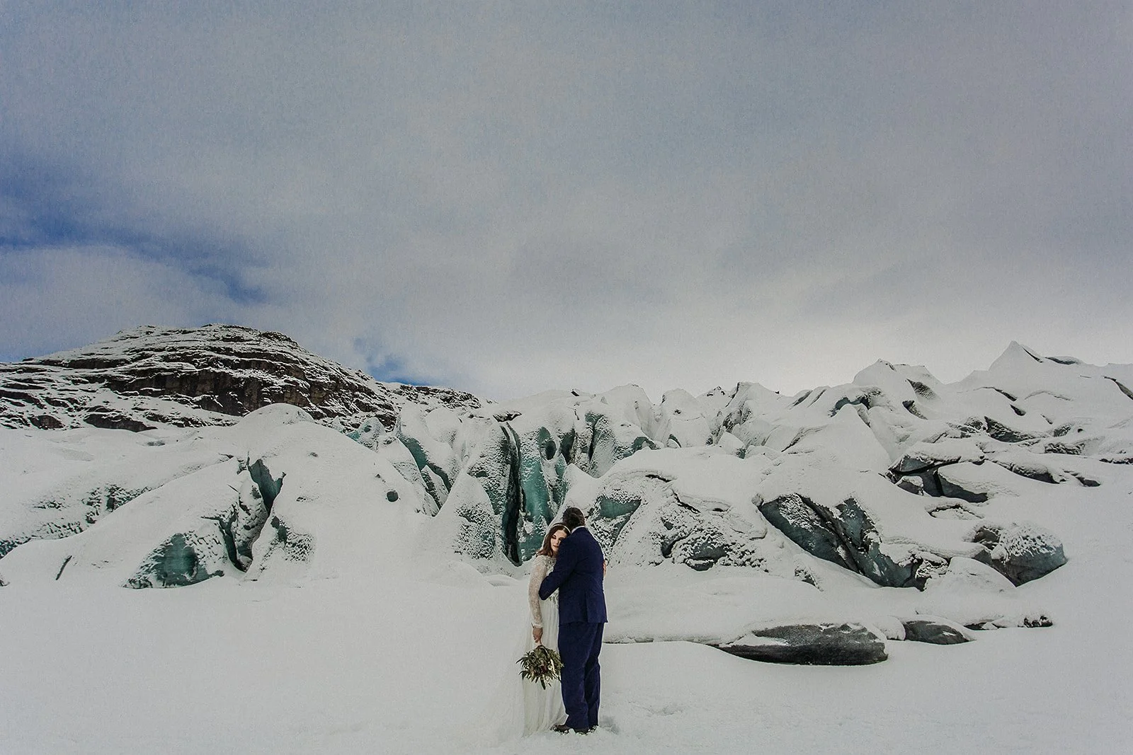 A Winter Iceland Elopement at Skógafoss (Skogafoss) and Glacier — couple at glacier