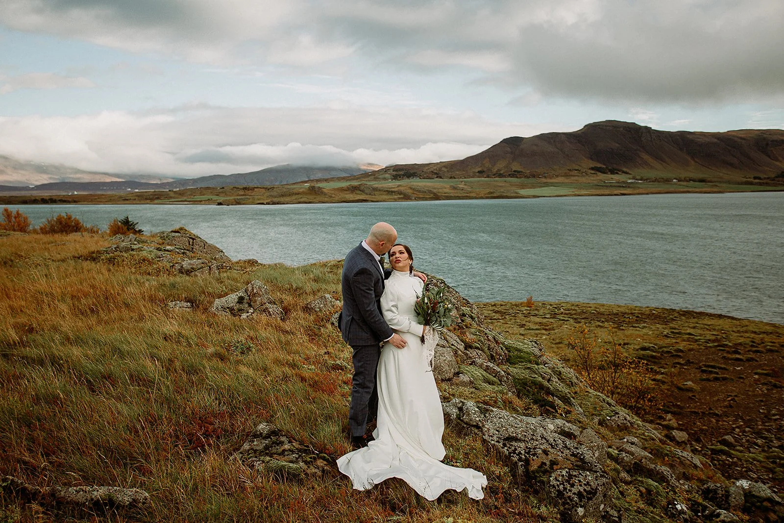 A Private Multi-Area Iceland Elopement by Steph Zakas Photography with wedding couple by fjord