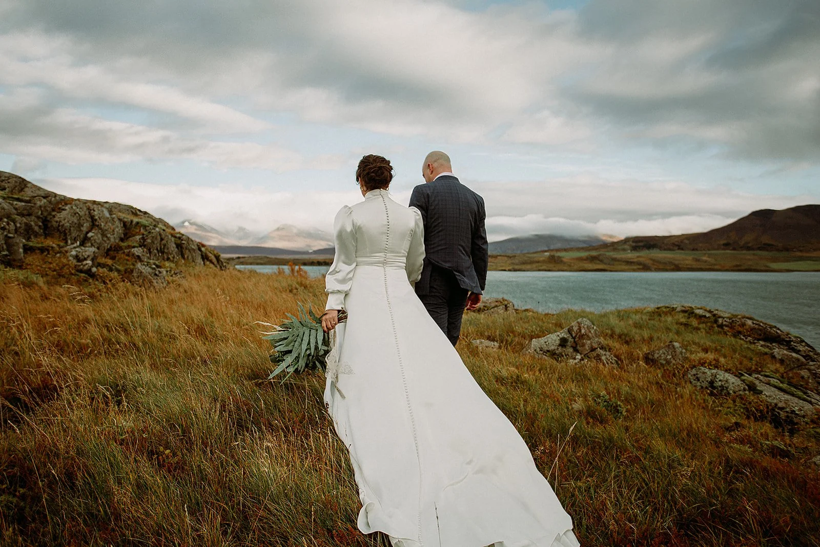 A Private Multi-Area Iceland Elopement by Steph Zakas Photography with wedding couple by fjord