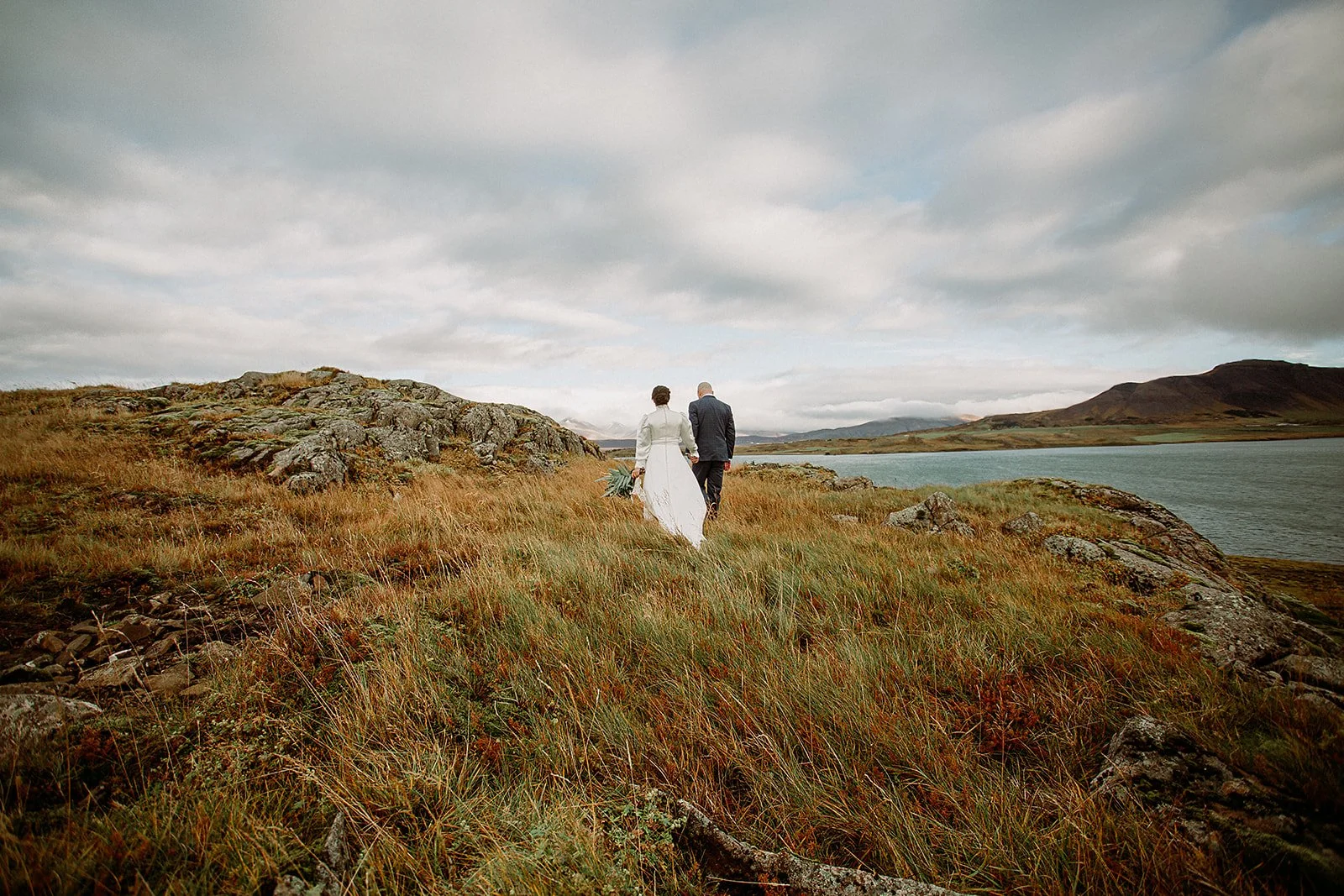 A Private Multi-Area Iceland Elopement by Steph Zakas Photography with wedding couple by fjord