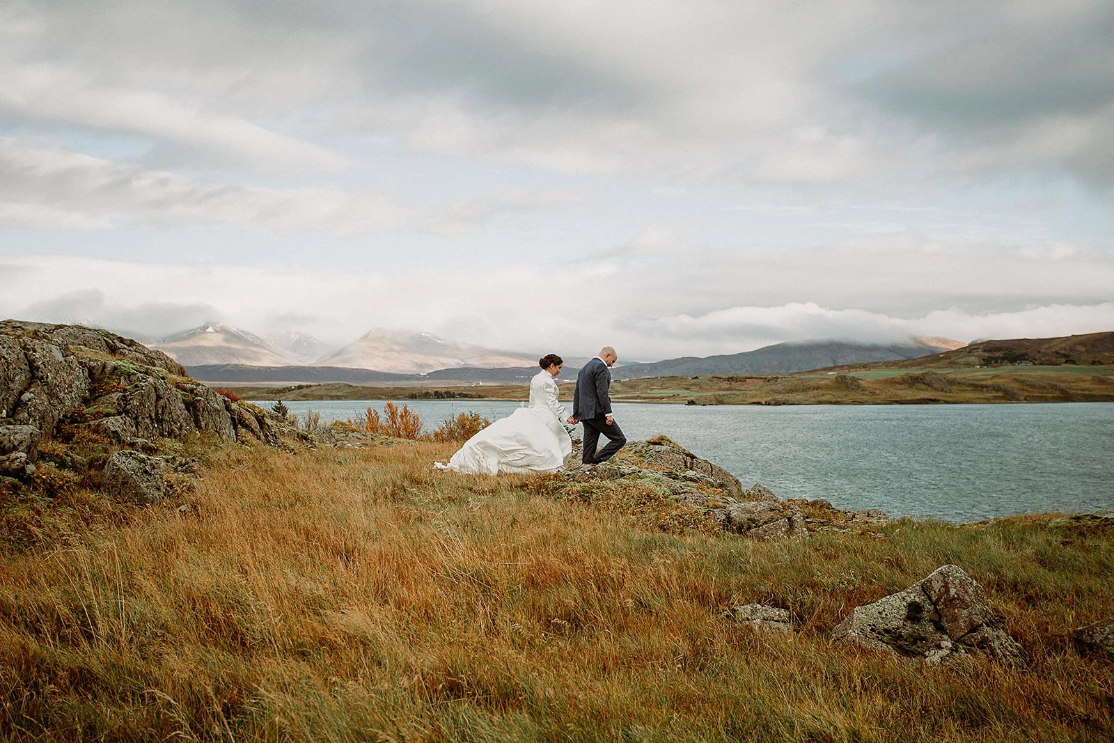 A Private Multi-Area Iceland Elopement by Steph Zakas Photography with wedding couple by fjord