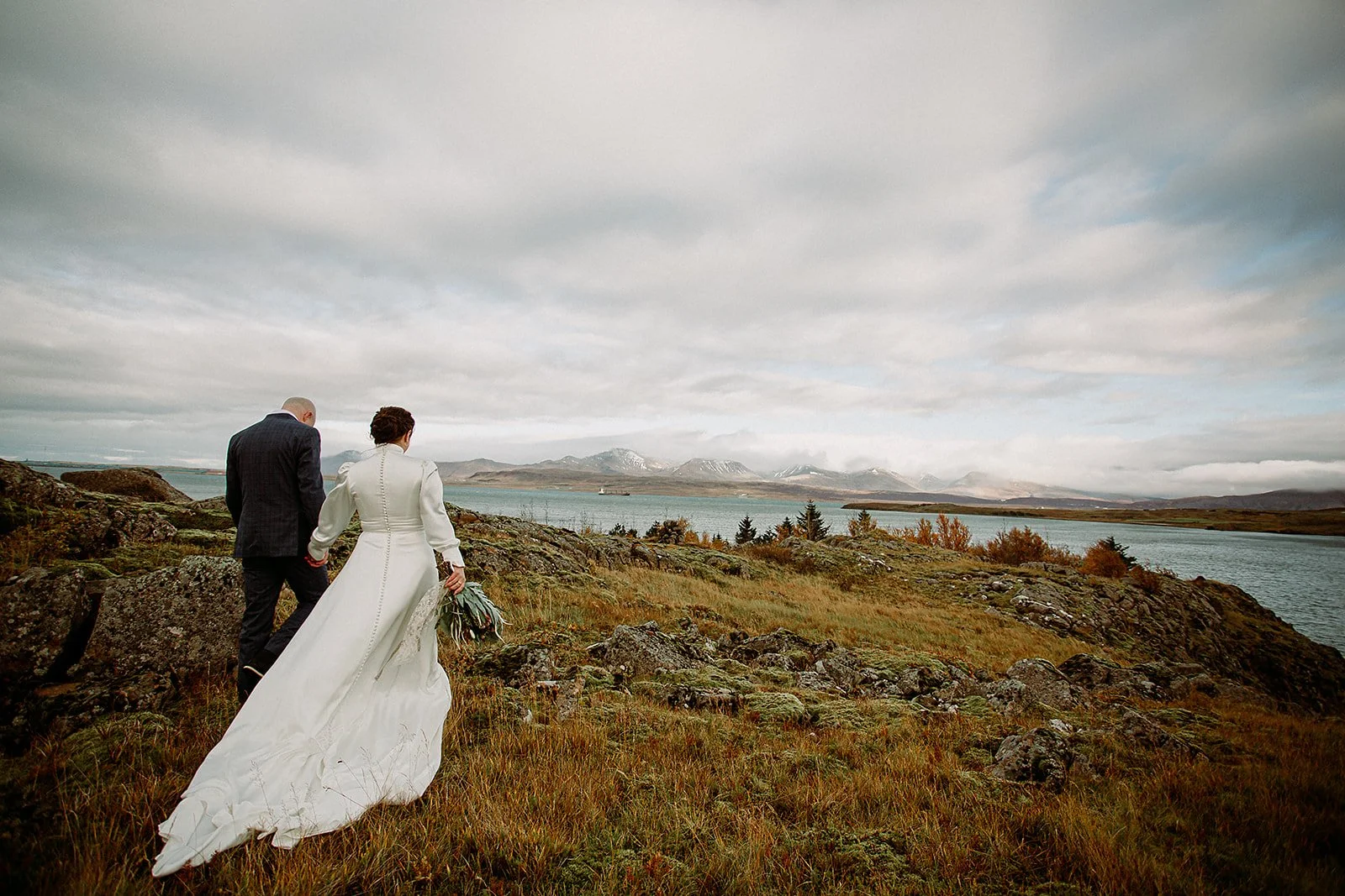 A Private Multi-Area Iceland Elopement by Steph Zakas Photography with wedding couple by fjord