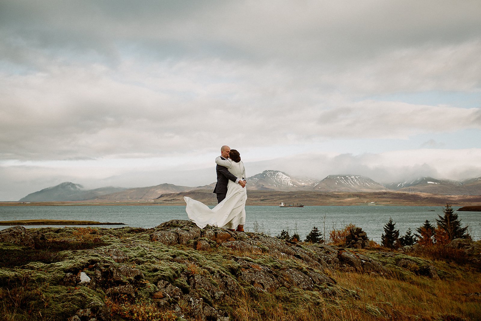 A Private Multi-Area Iceland Elopement by Steph Zakas Photography with wedding couple by fjord