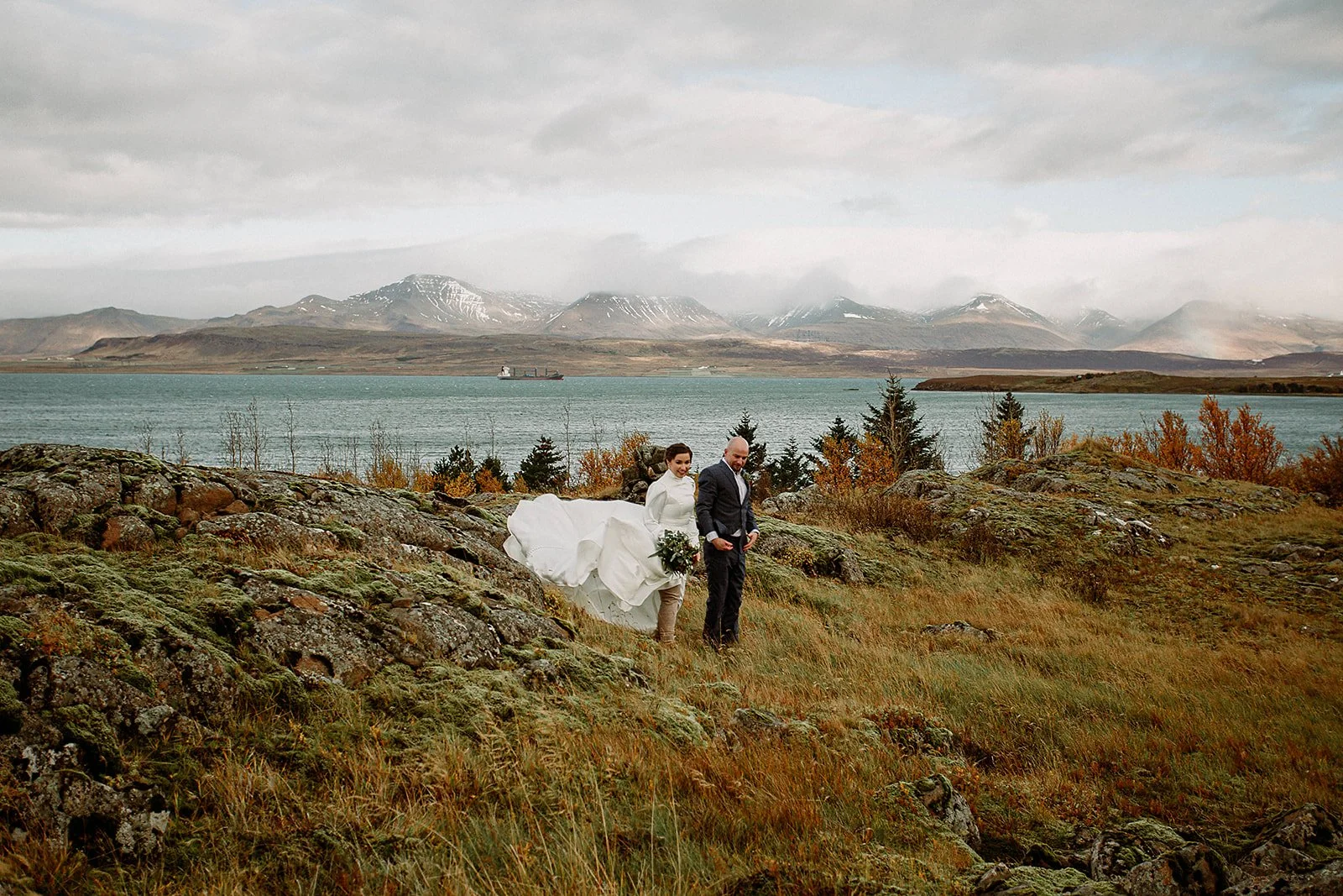 A Private Multi-Area Iceland Elopement by Steph Zakas Photography with wedding couple by fjord