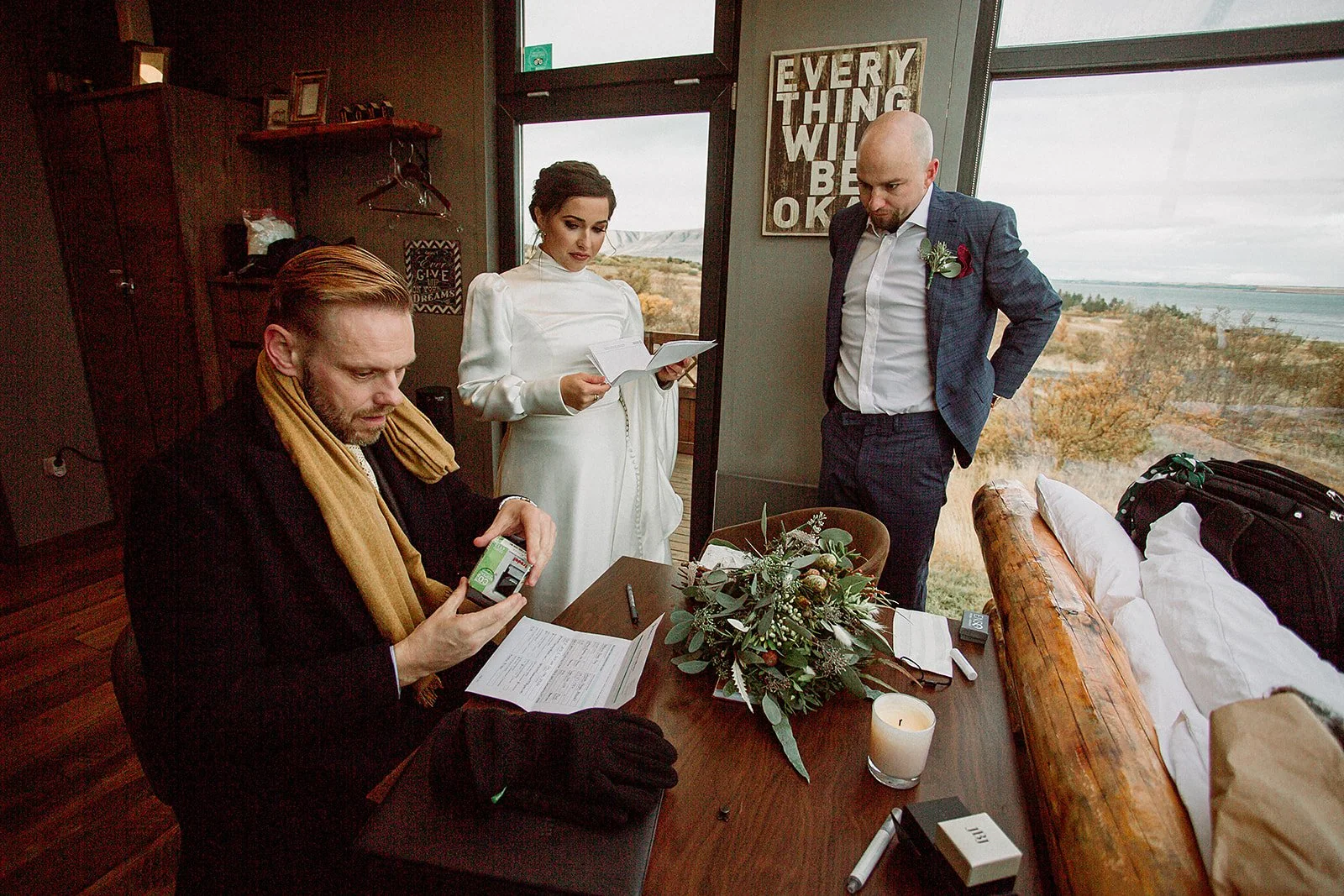 A Private Multi-Area Iceland Elopement by Steph Zakas Photography with wedding couple singing papers