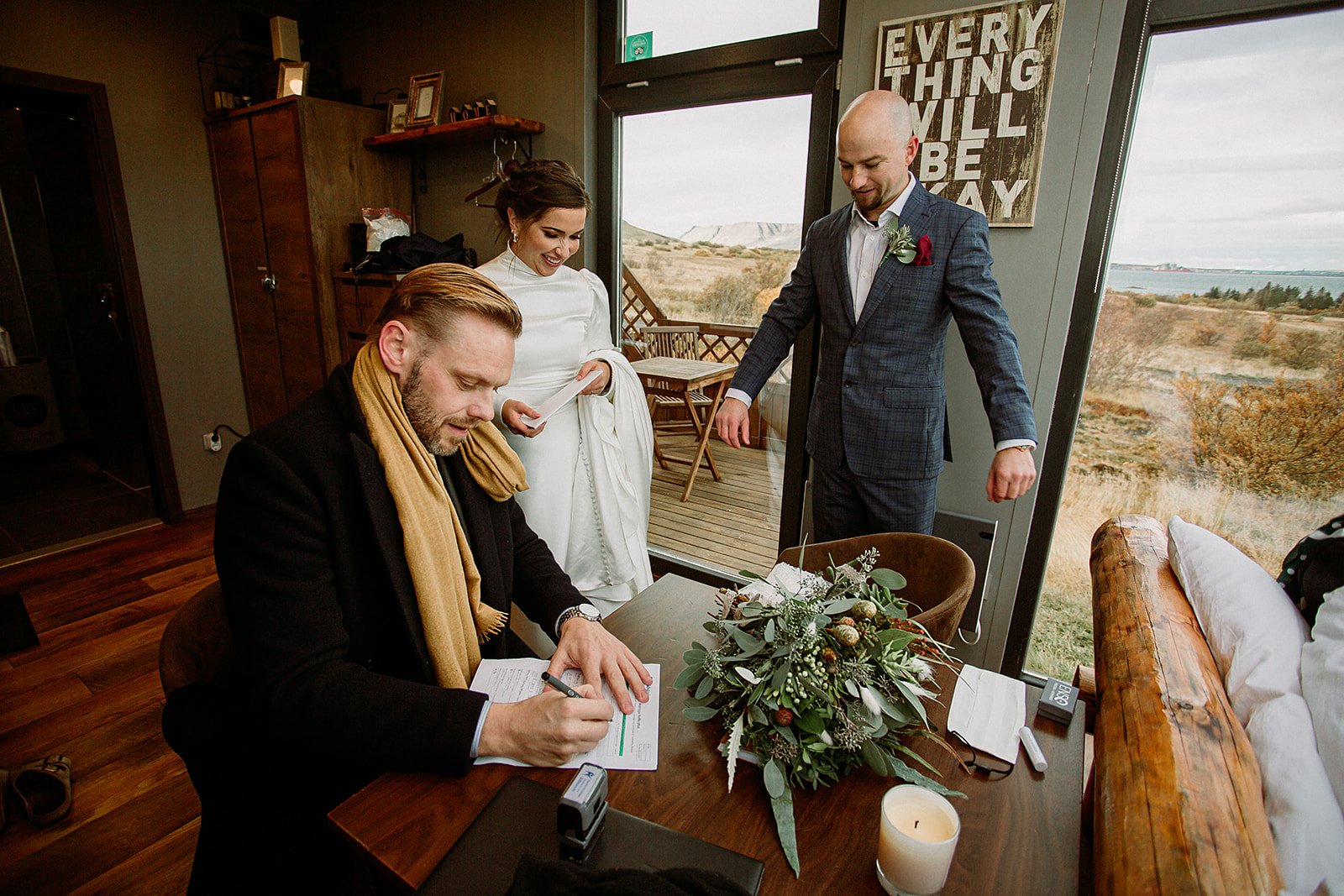 A Private Multi-Area Iceland Elopement by Steph Zakas Photography with wedding couple singing papers