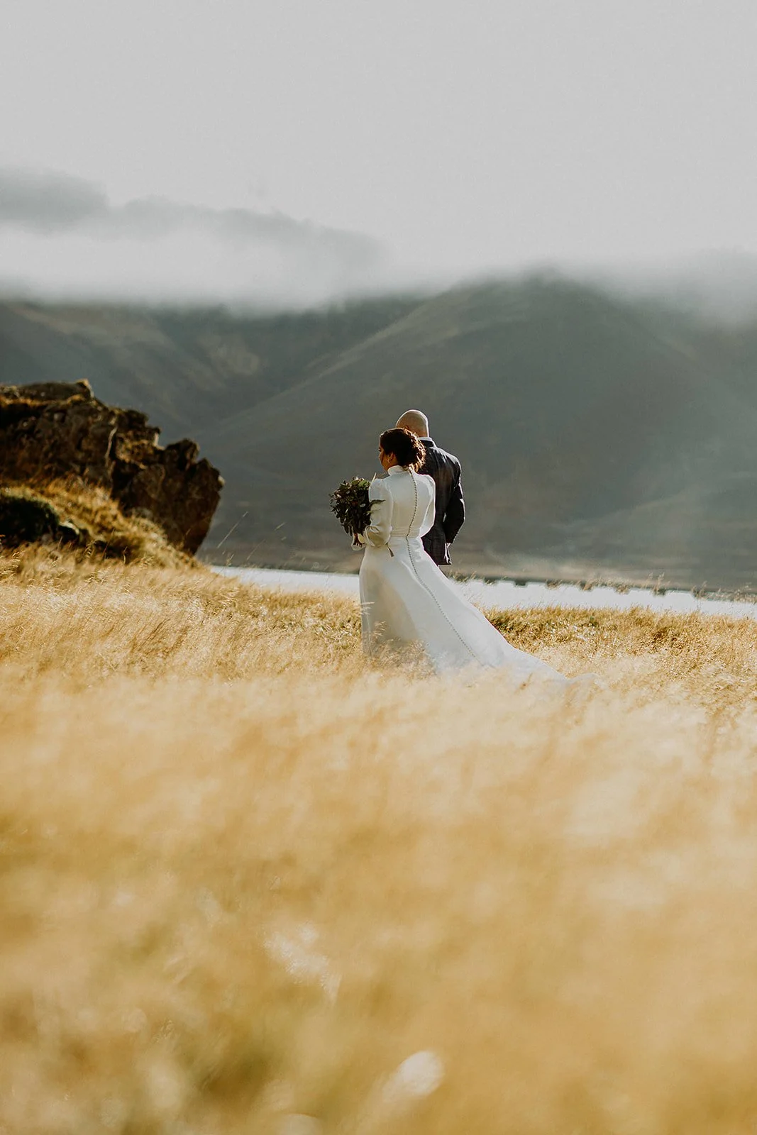 A Private Multi-Area Iceland Elopement by Steph Zakas Photography with wedding couple at fjord