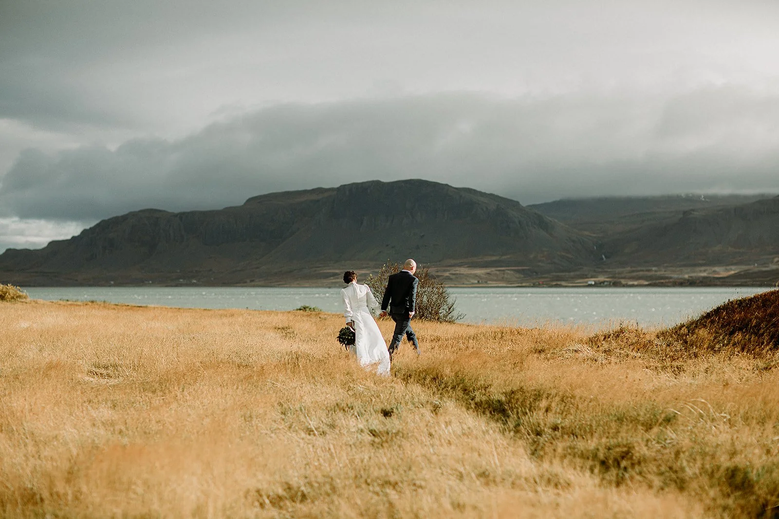 A Private Multi-Area Iceland Elopement by Steph Zakas Photography with wedding couple at fjord