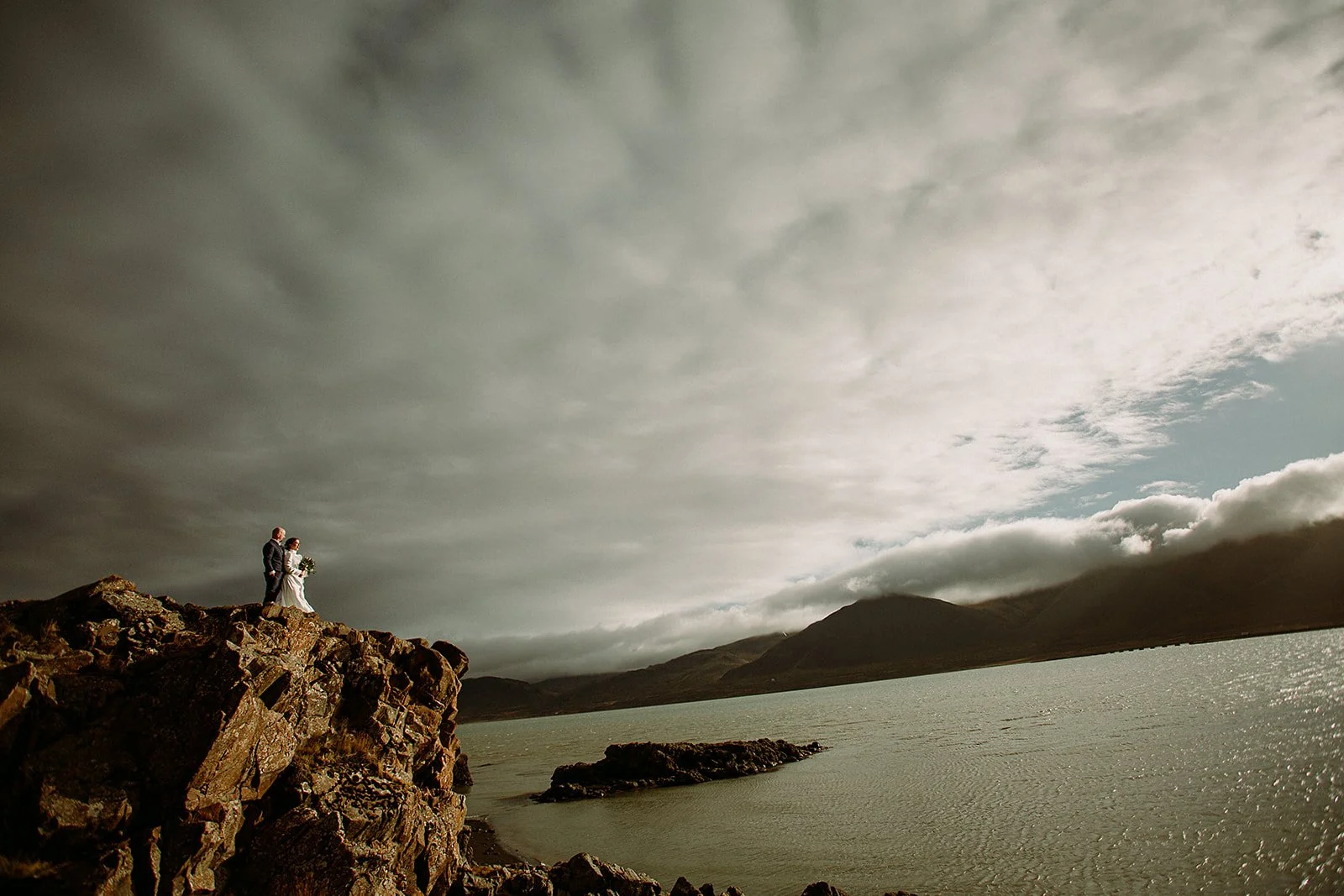 A Private Multi-Area Iceland Elopement by Steph Zakas Photography with wedding couple at fjord