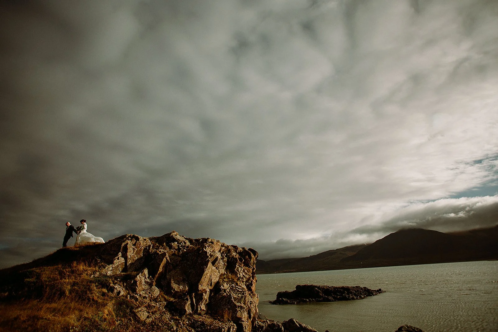 A Private Multi-Area Iceland Elopement by Steph Zakas Photography with wedding couple at fjord