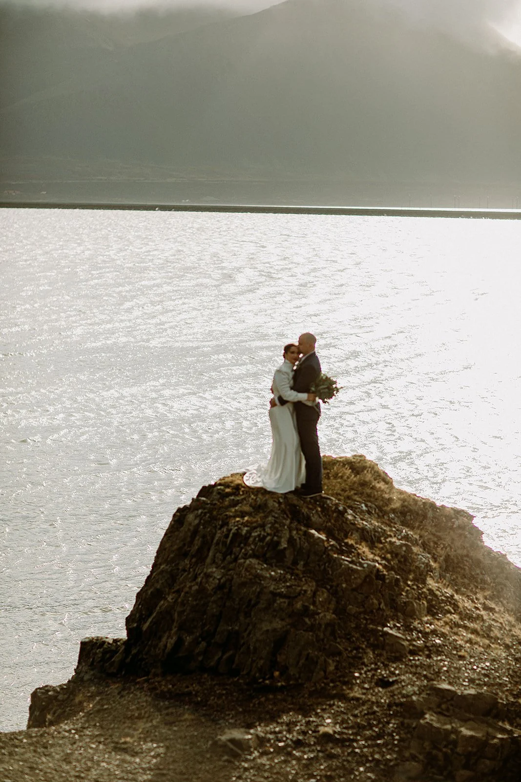 A Private Multi-Area Iceland Elopement by Steph Zakas Photography with wedding couple at fjord