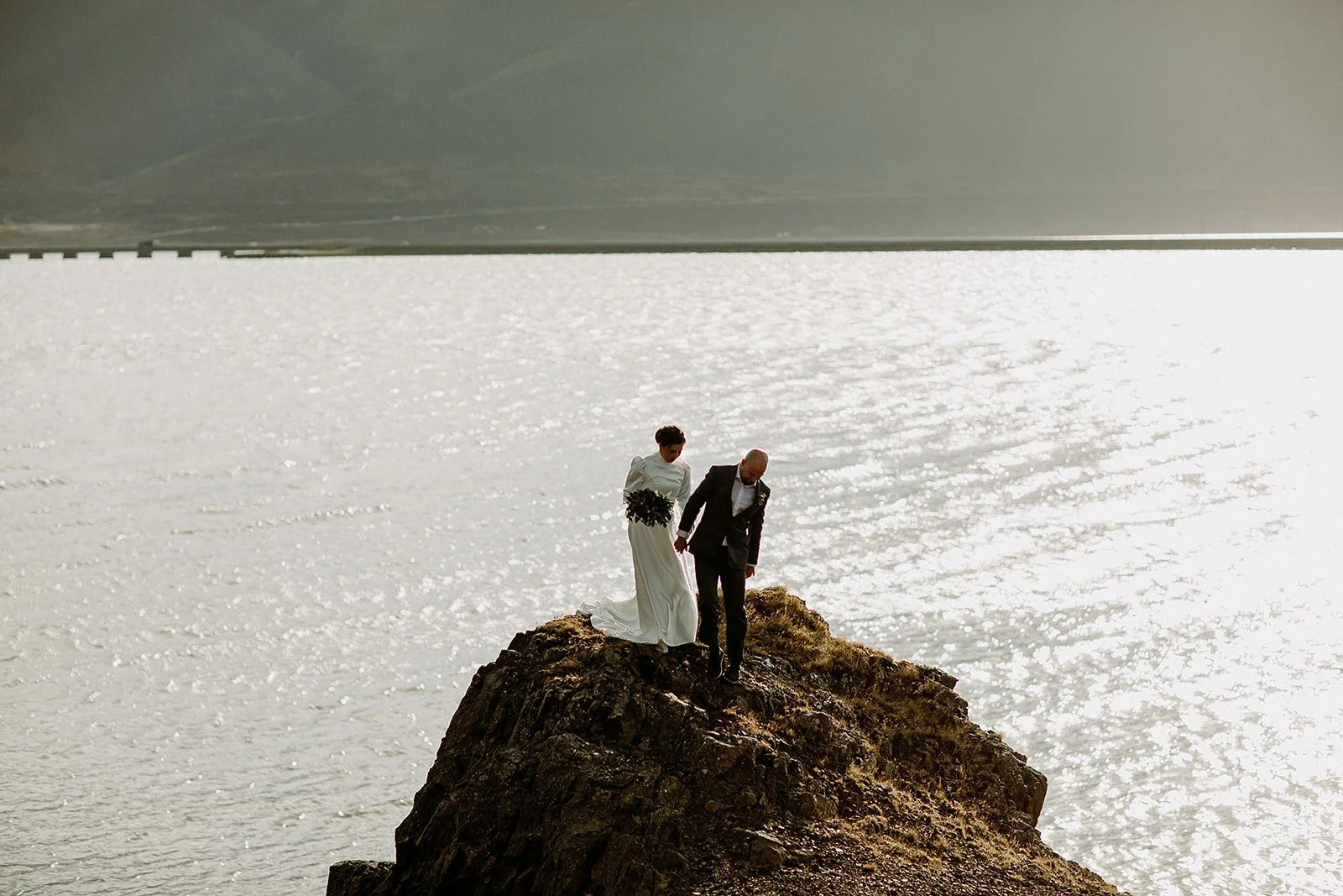 A Private Multi-Area Iceland Elopement by Steph Zakas Photography with wedding couple at fjord
