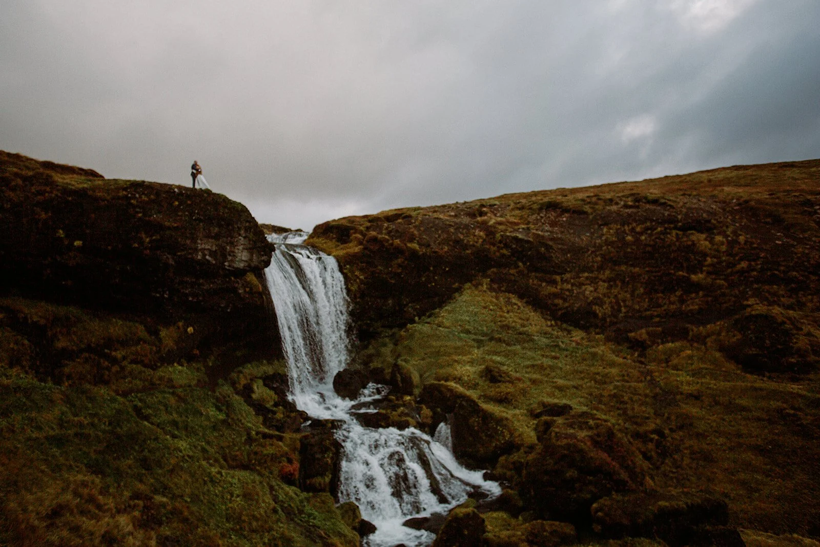 A Private Multi-Area Iceland Elopement by Steph Zakas Photography with wedding couple at secluded waterfall