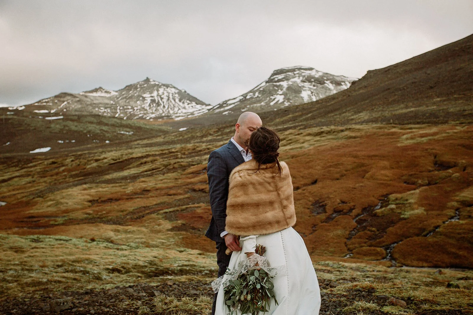 A Private Multi-Area Iceland Elopement by Steph Zakas Photography with wedding couple at mountain 