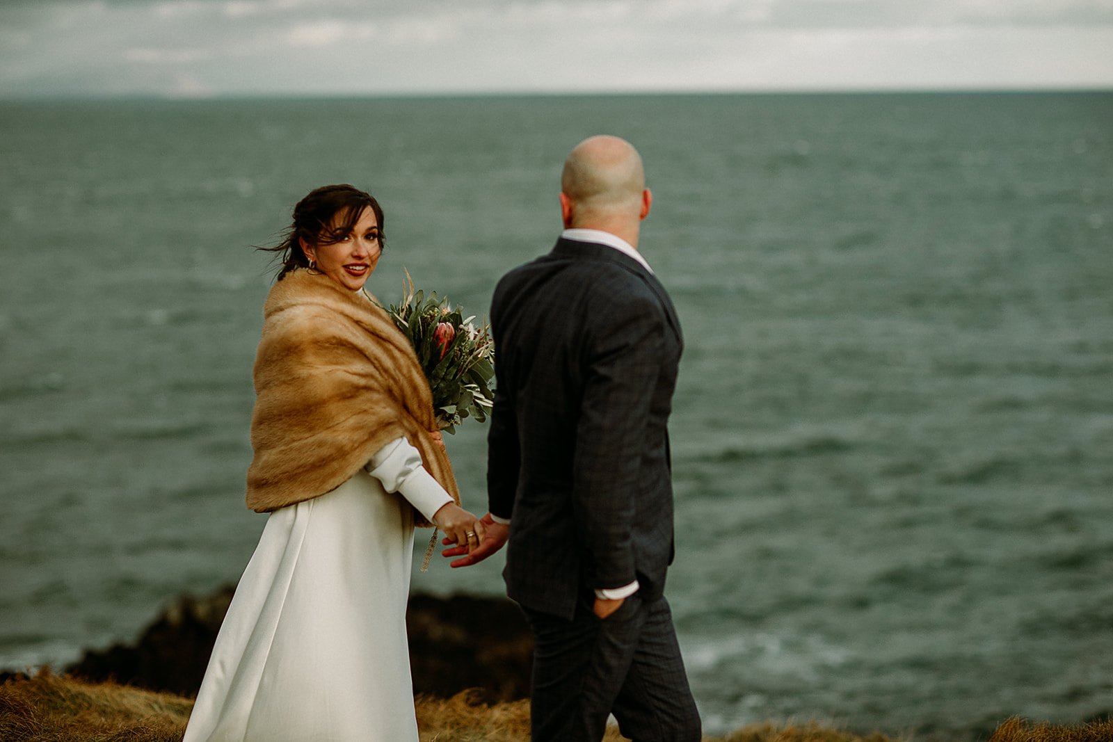 A Private Multi-Area Iceland Elopement by Steph Zakas Photography with wedding couple at sea cliff
