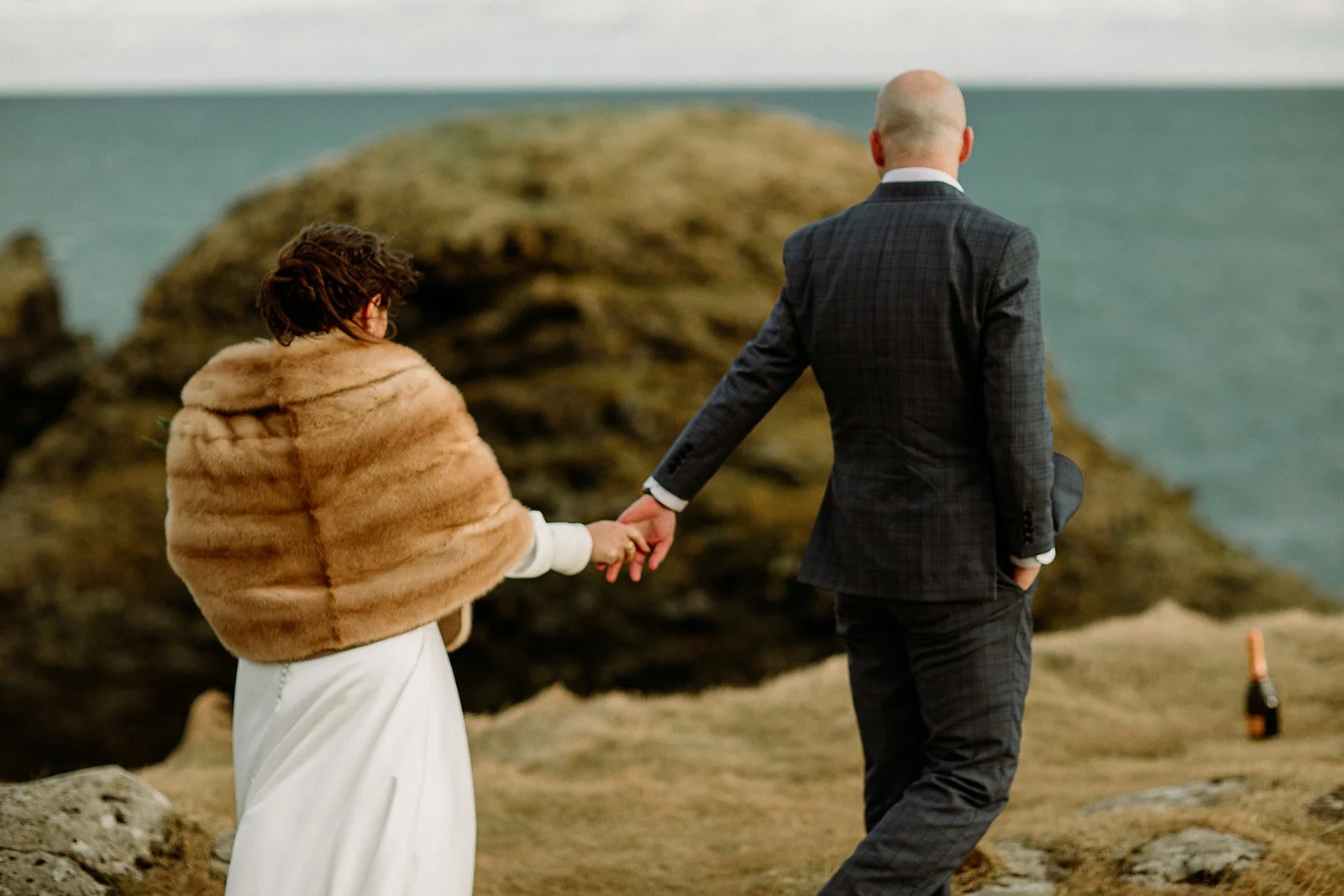 A Private Multi-Area Iceland Elopement by Steph Zakas Photography with wedding couple at sea cliff