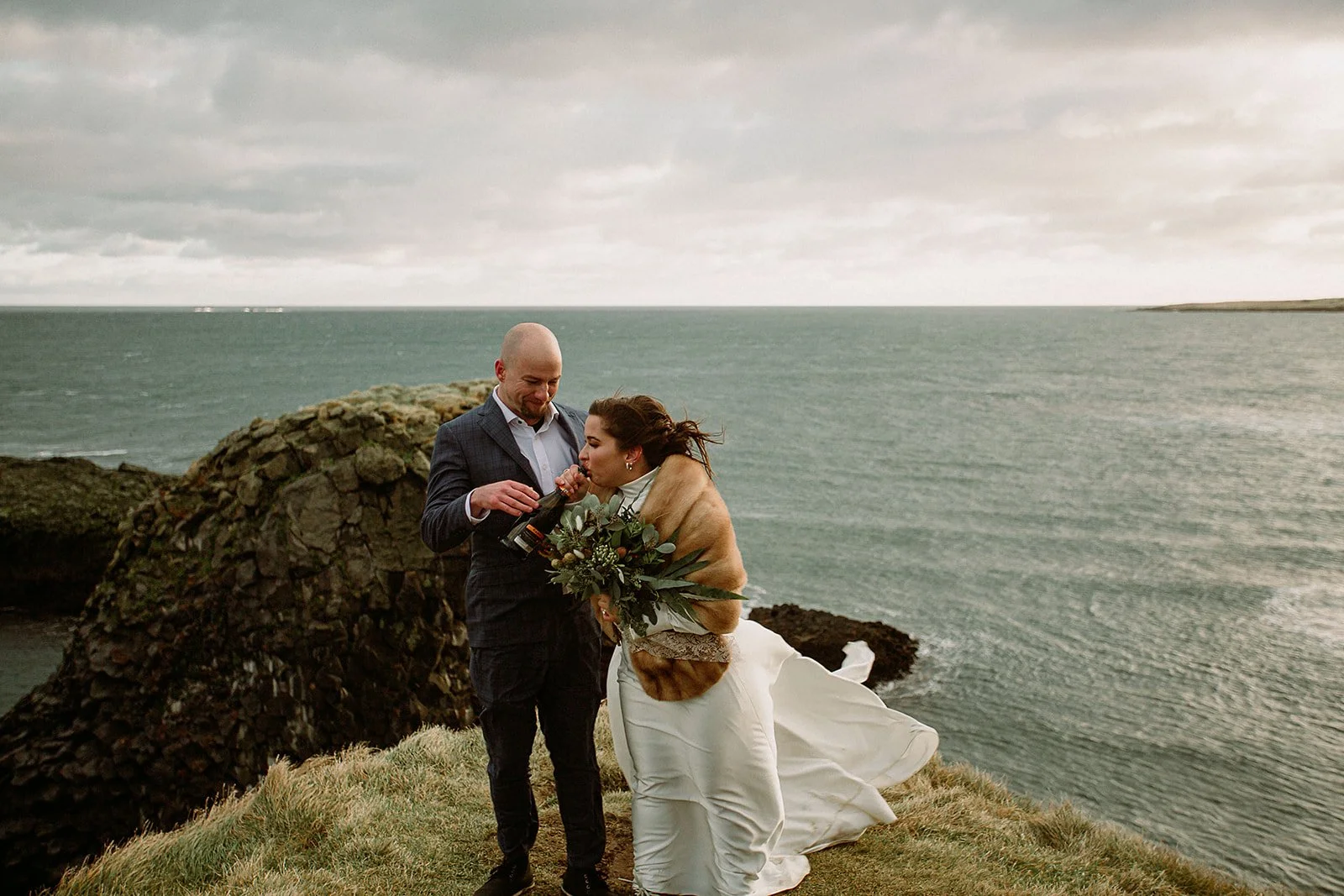 A Private Multi-Area Iceland Elopement by Steph Zakas Photography with wedding couple at sea cliff