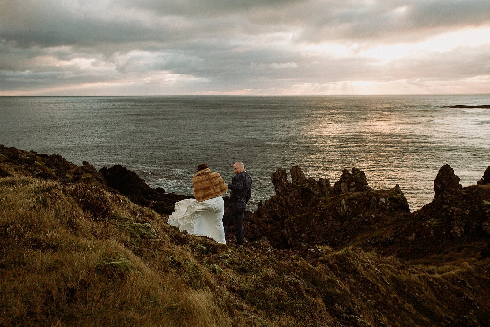 A Private Multi-Area Iceland Elopement by Steph Zakas Photography with wedding couple at sea cliff